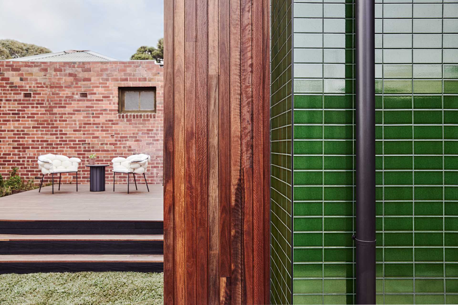 A modern home addition with glazed green tiles.
