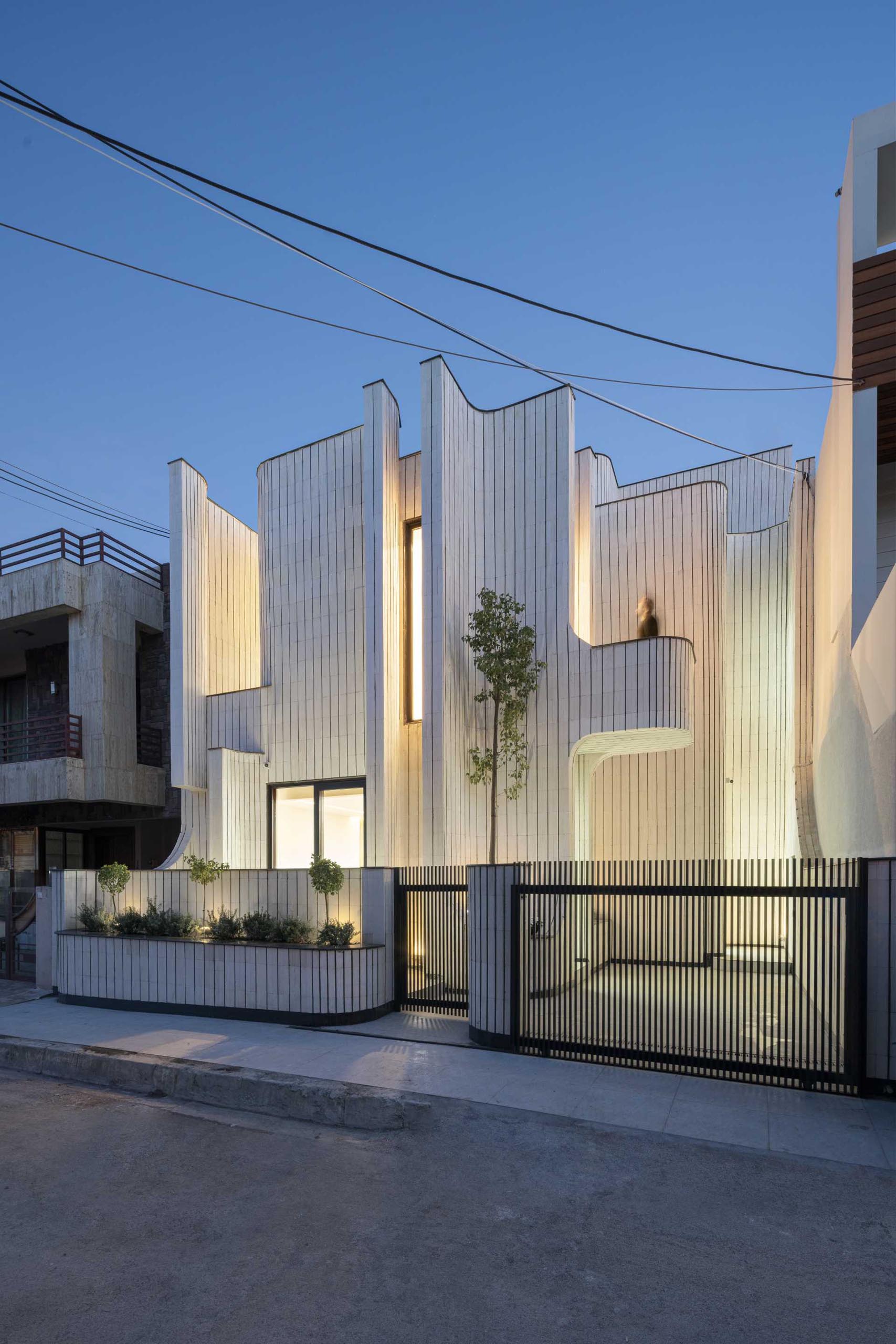 Exterior lighting showcases the sculptural design of this modern house.