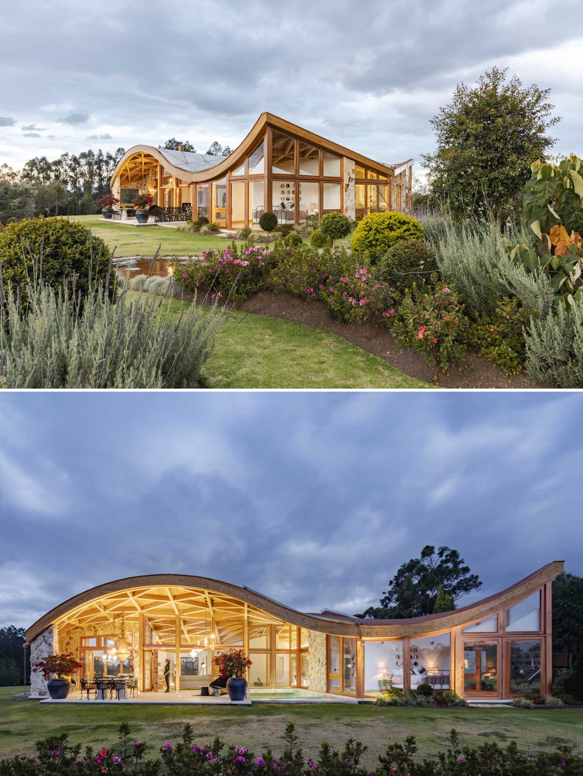 A modern wood house with glass walls and a wavy roof.