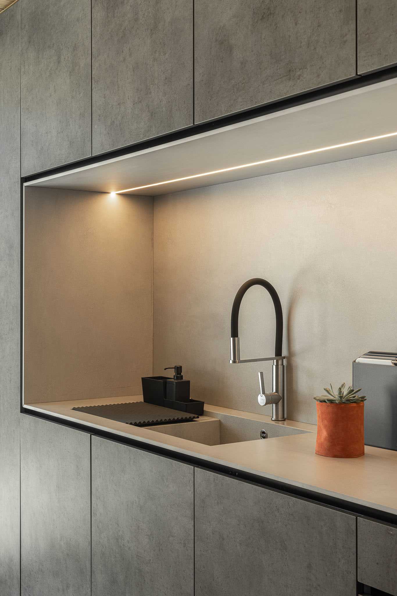 A modern kitchen with a built-in light about the kitchen.
