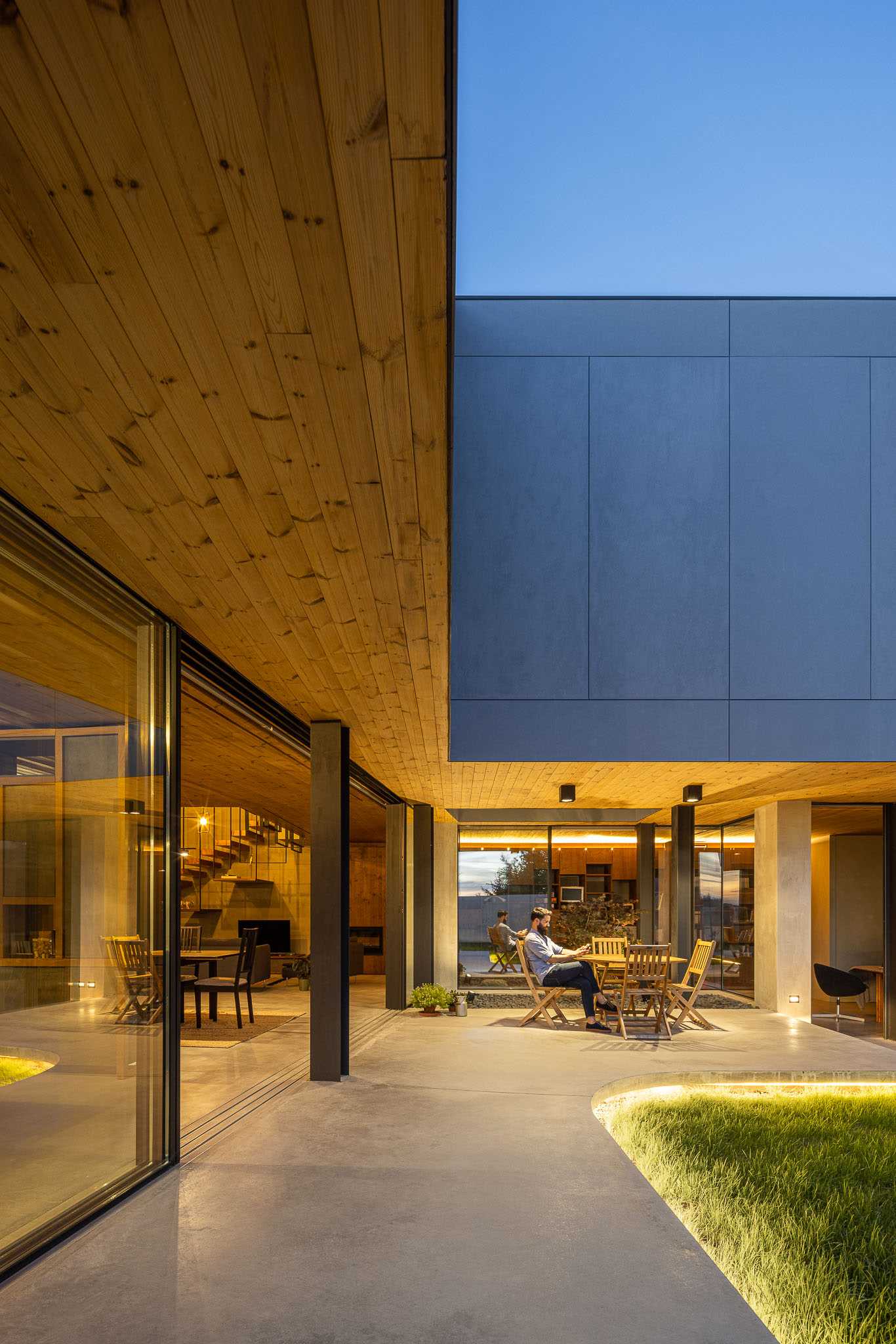 A modern curved concrete patio with hidden lighting.