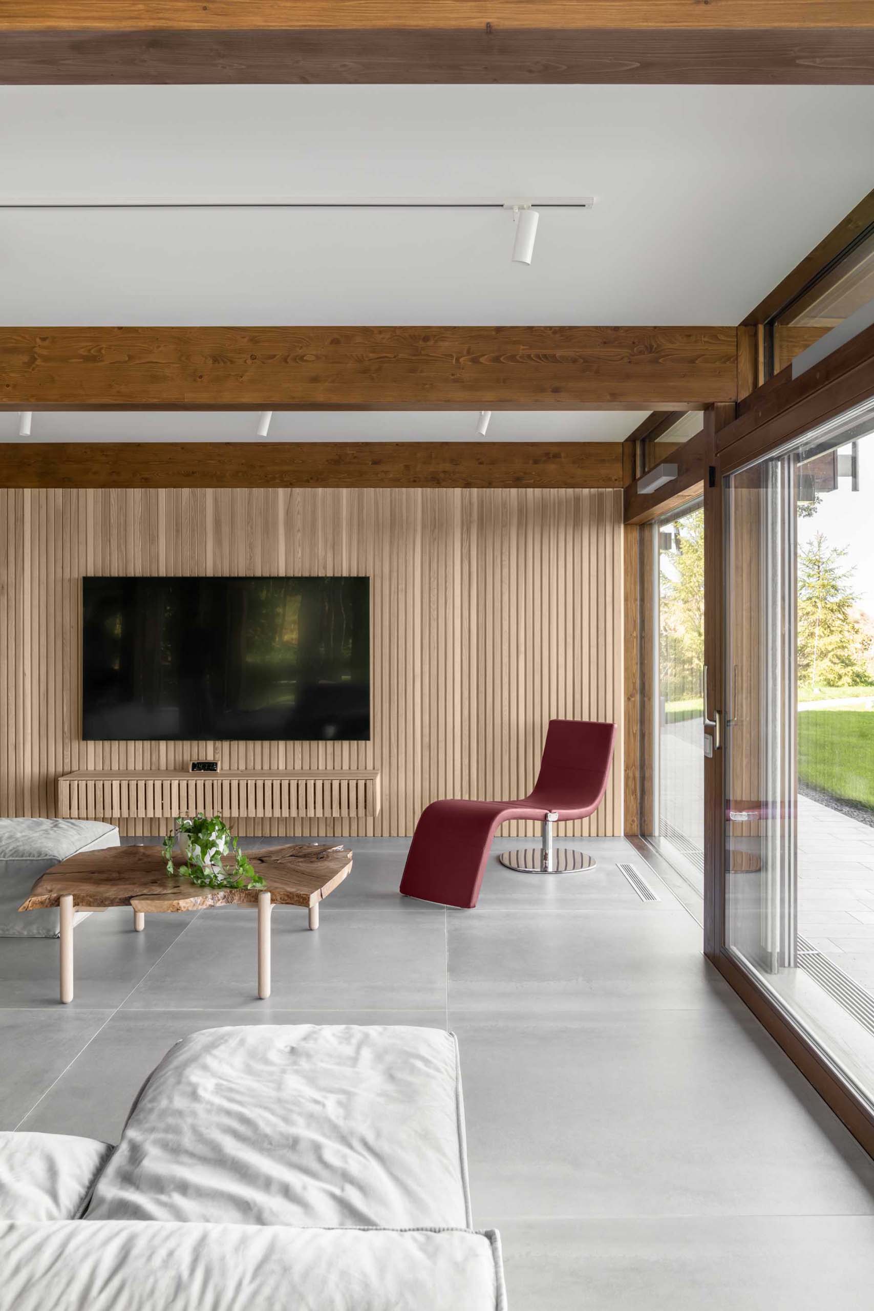 A modern living room with a wood slat accent wall and matching floating console.