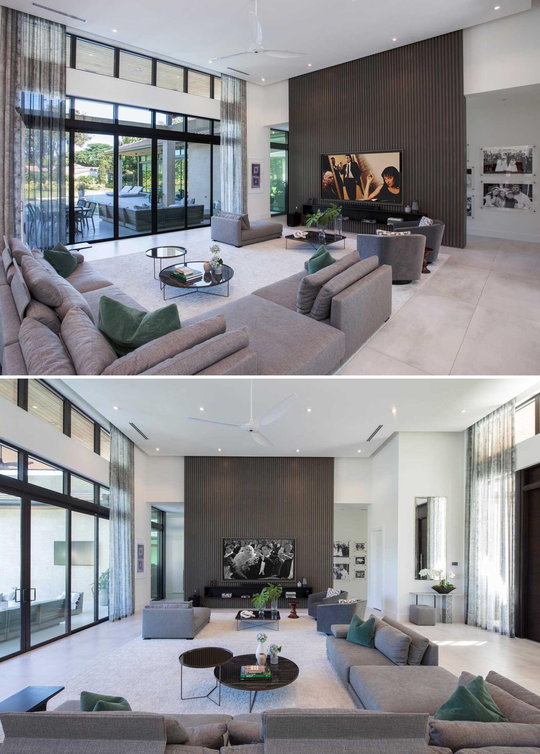 This living room has a vertical wood accent wall that draws the eye upward to the high ceiling.