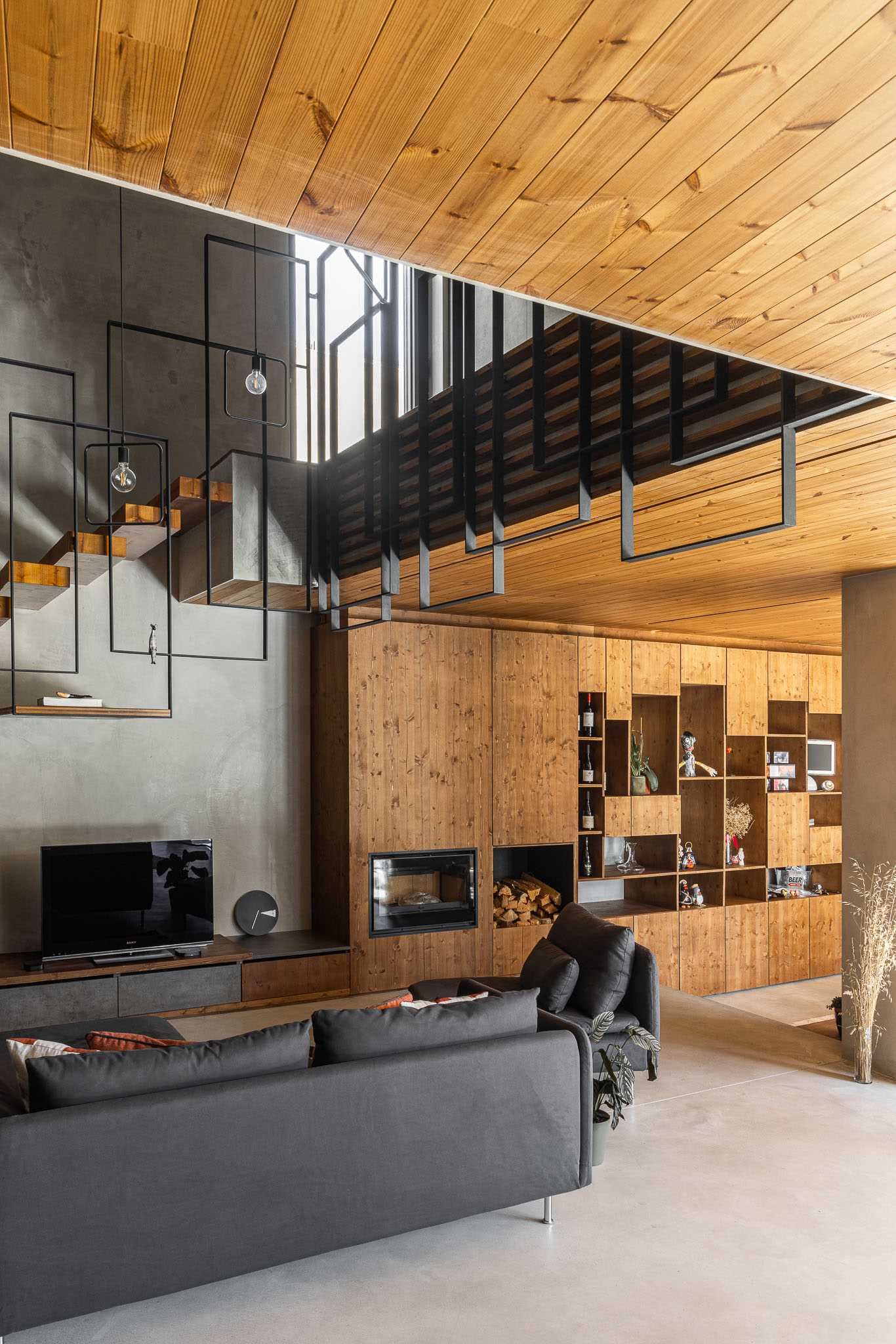 A modern living room with a nearby bookshelf.