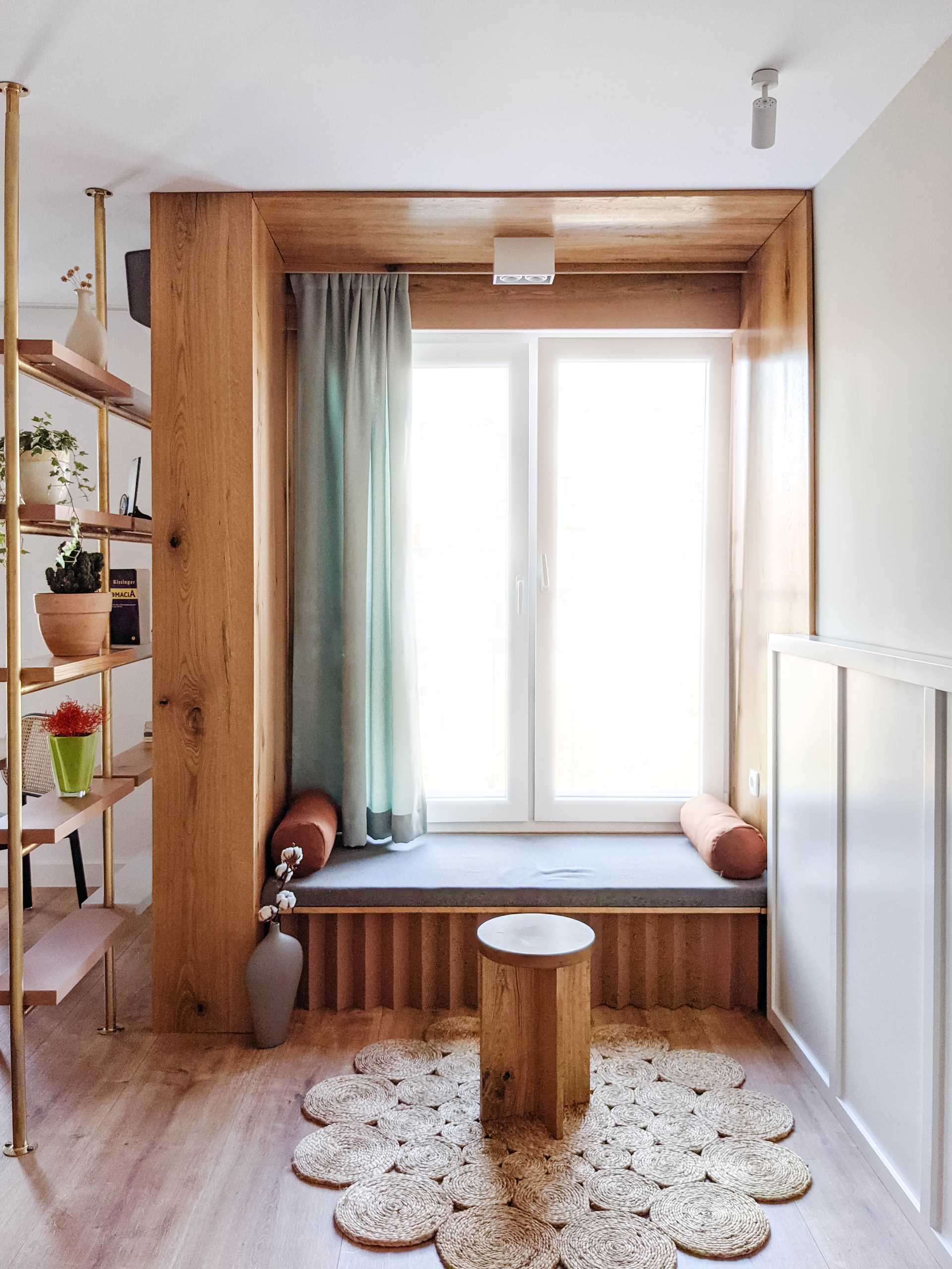 A built-in window seat lined with wood.