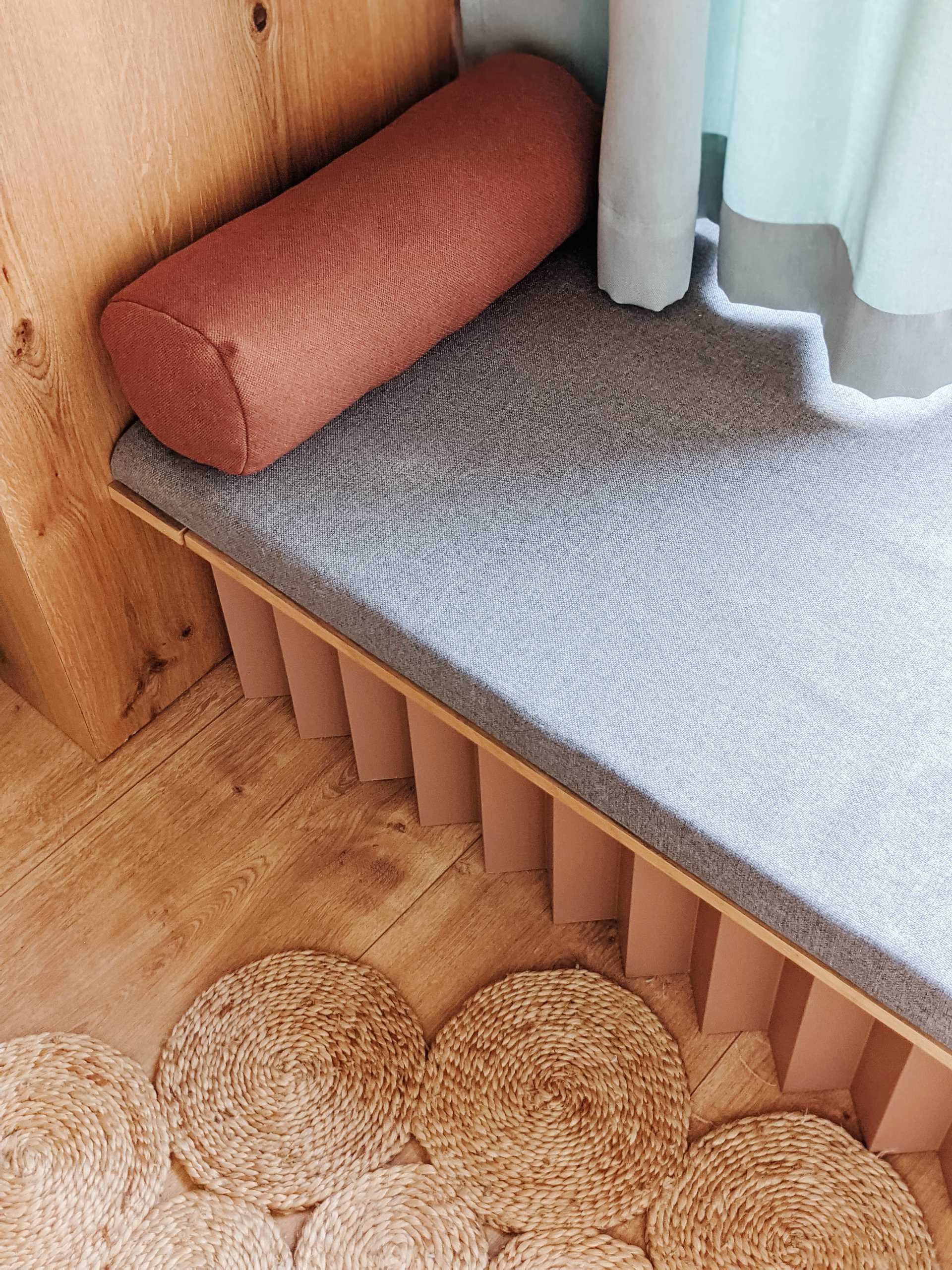 A built-in window seat lined with wood.