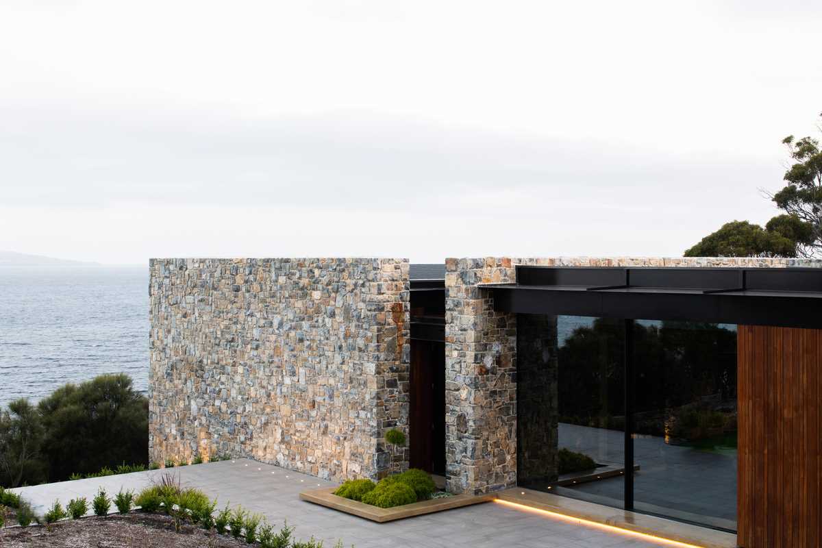 A modern house with mudstone walls.
