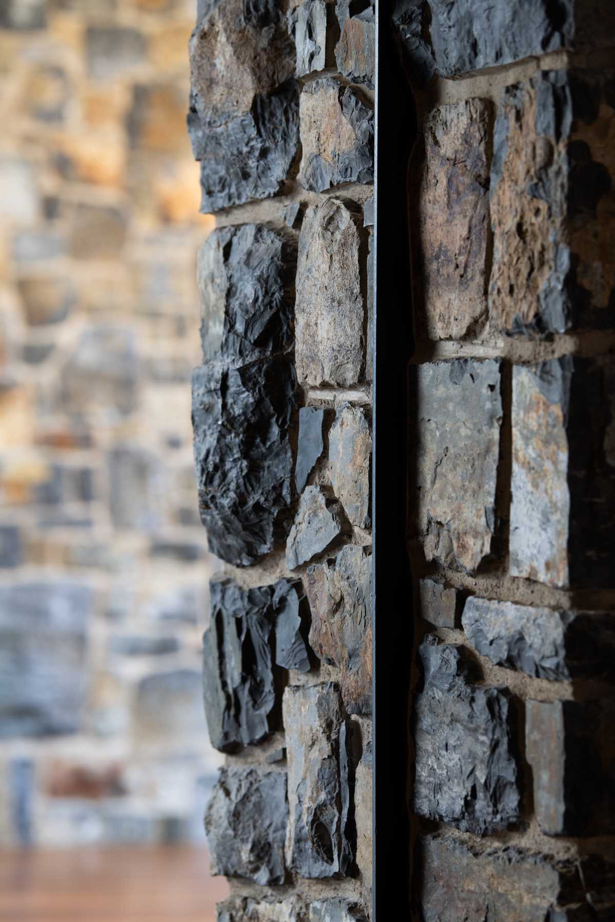 A modern house with stone walls.