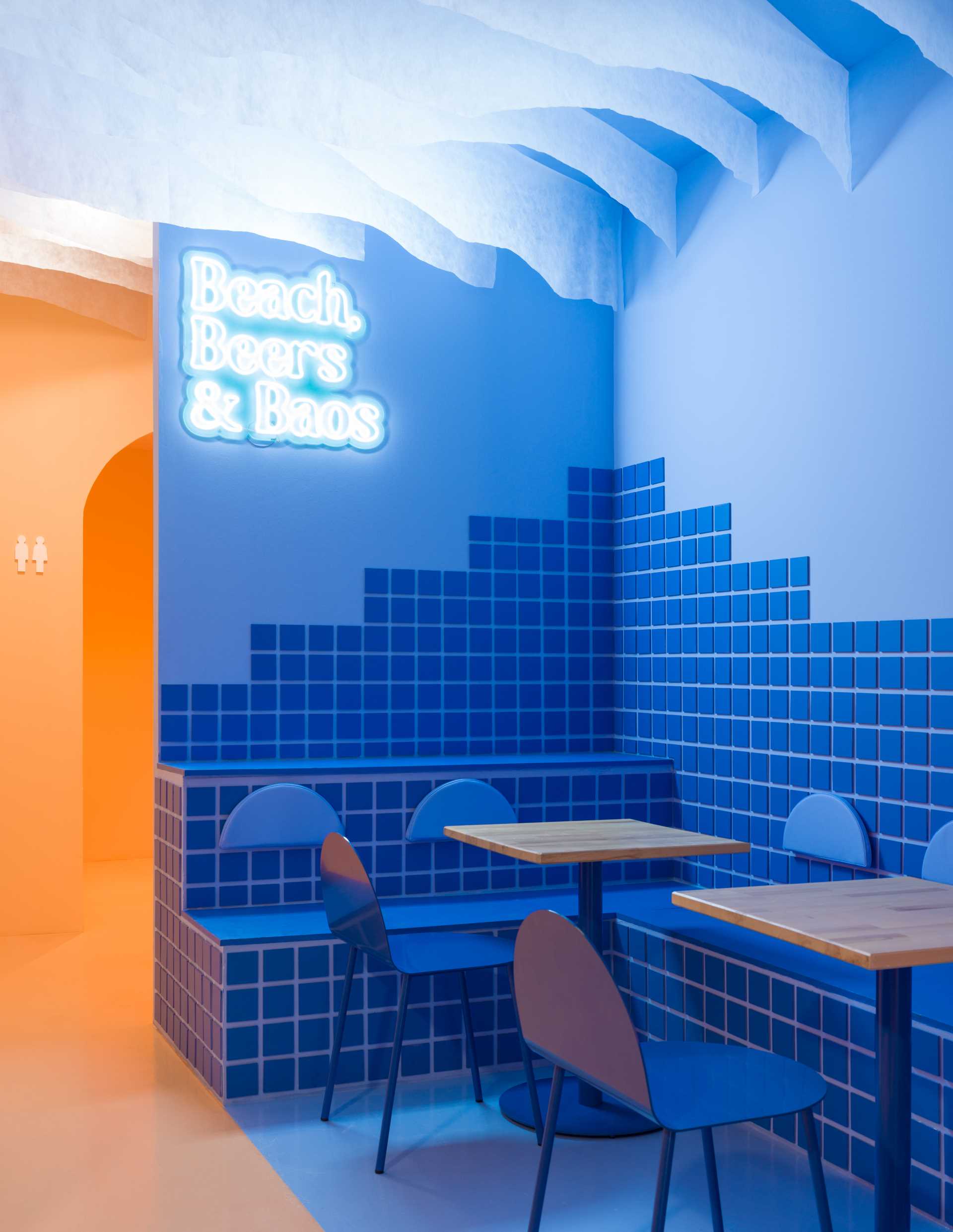 A modern and colorful restaurant interior inspired by a beach sunset.