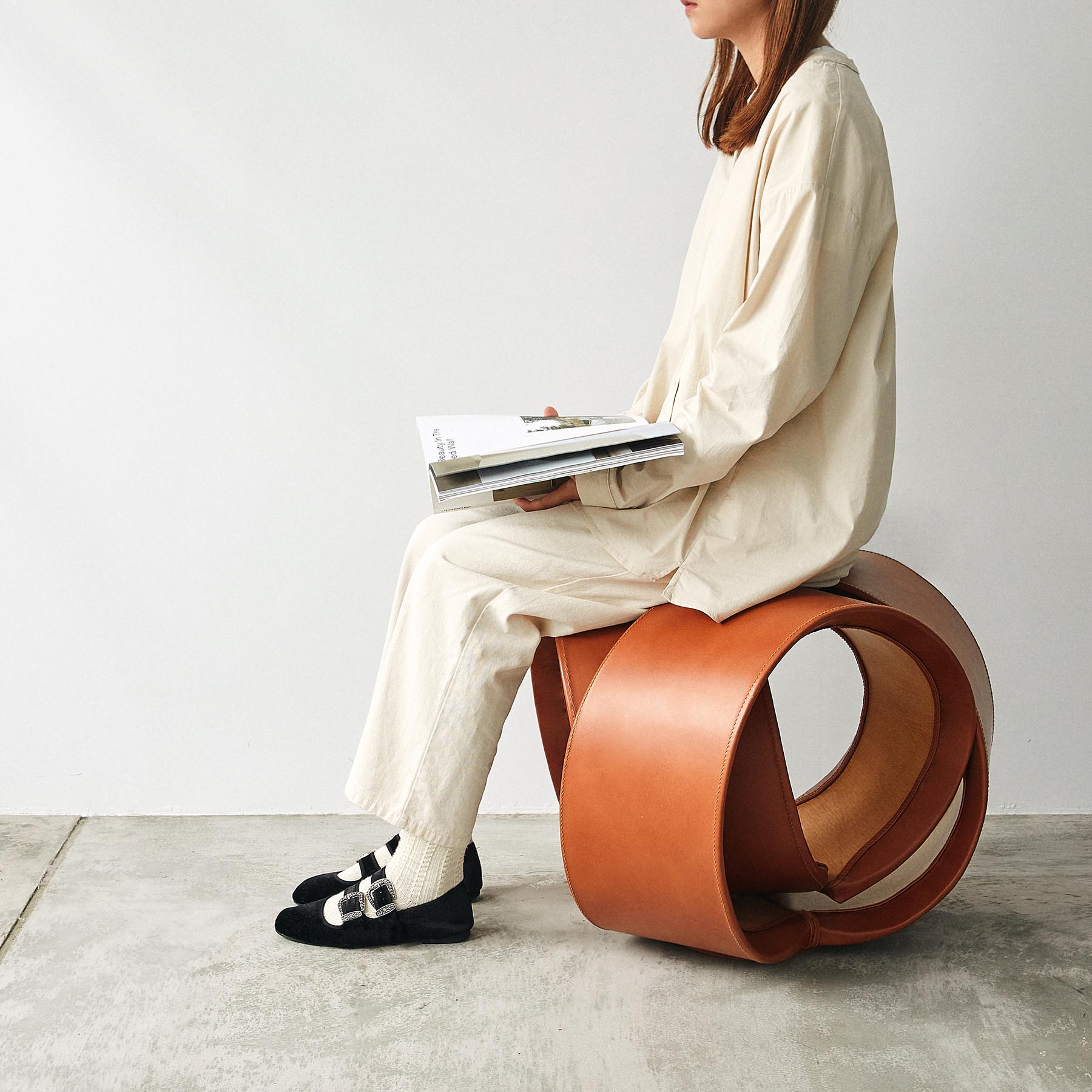 Inspired by circular geometry found in nature, this modern stool, made from wood and leather, transforms soft and solid materials into comfortable seat.