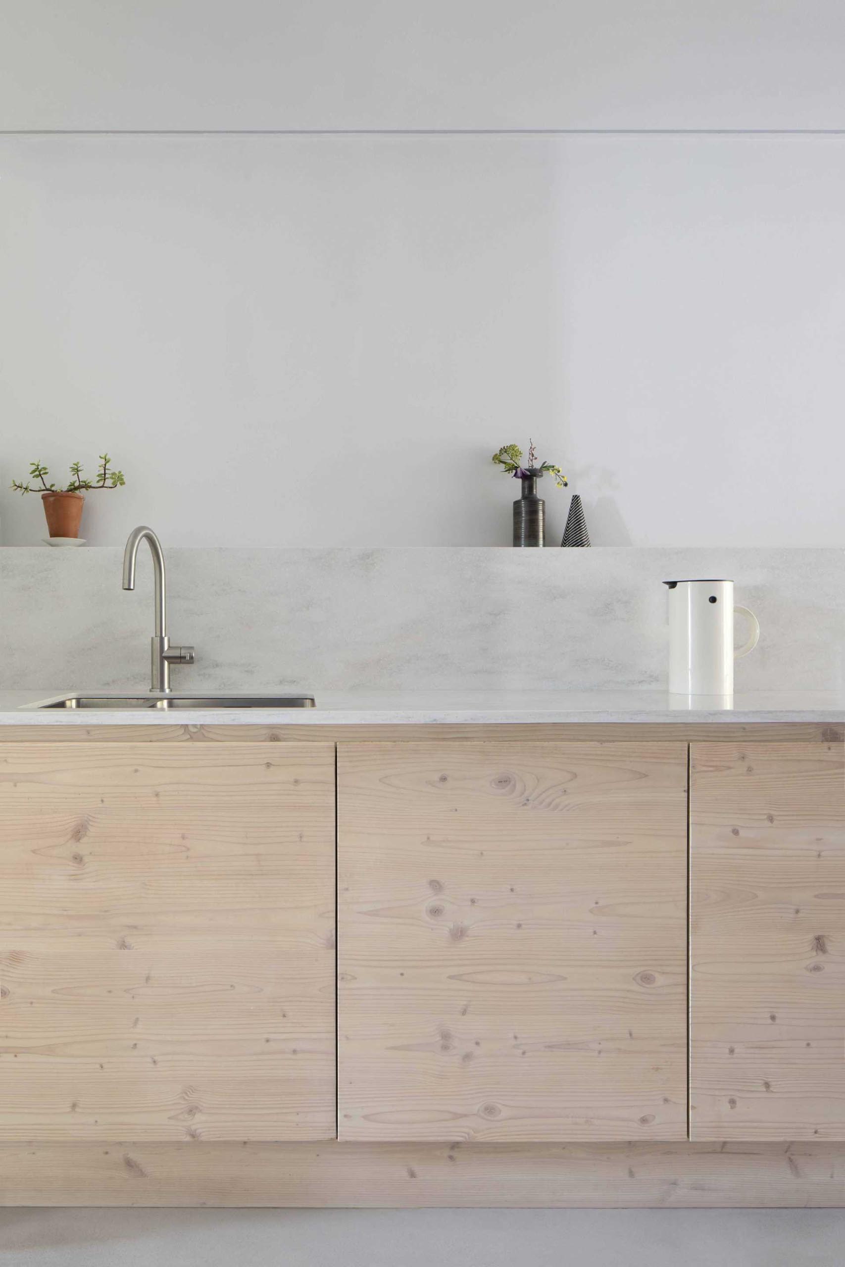 A contemporary galley kitchen with wood cabinets.