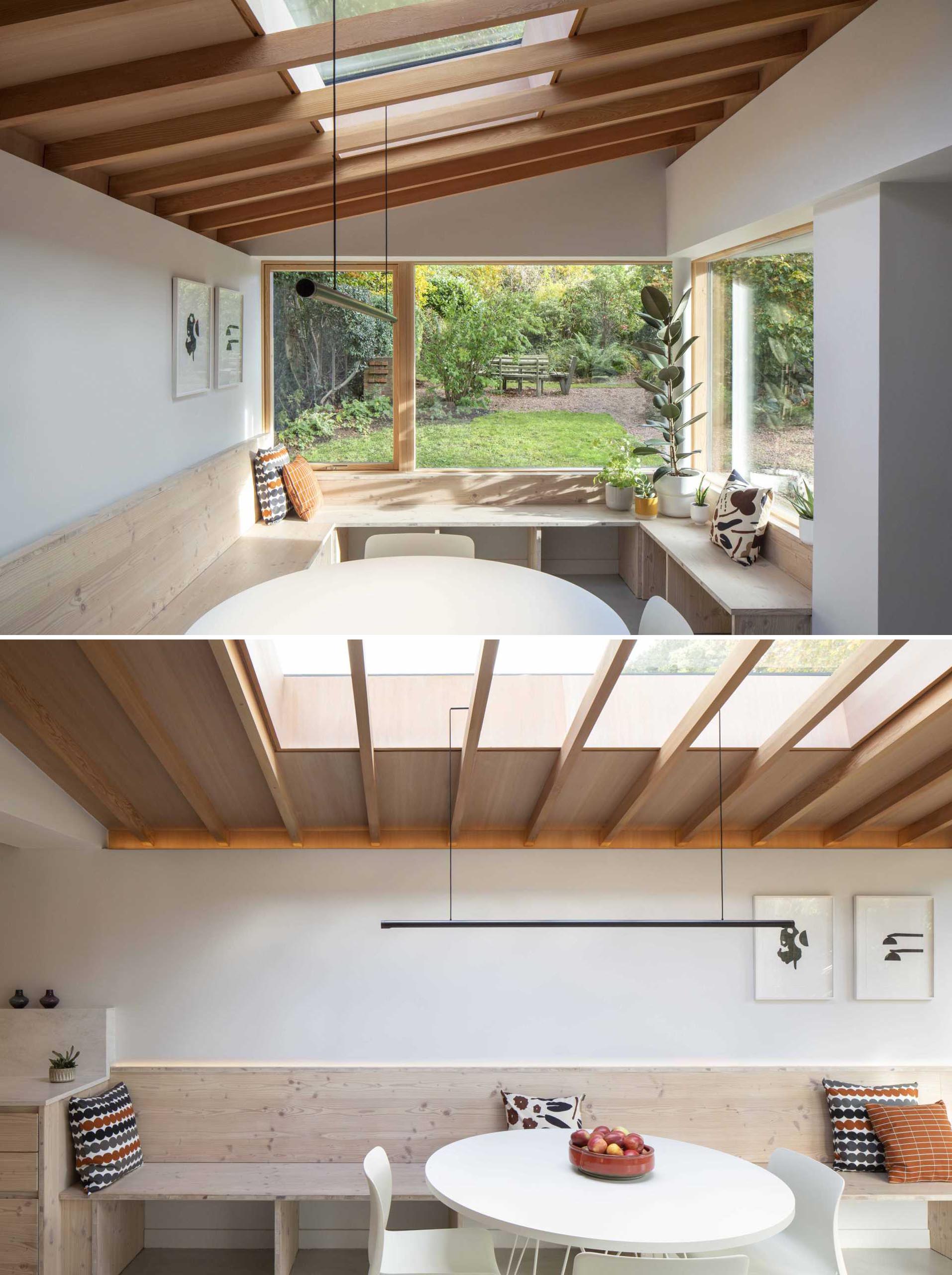 The window bench has a U-shape, and is positioned to take advantage of both of the large windows and the views of the garden.