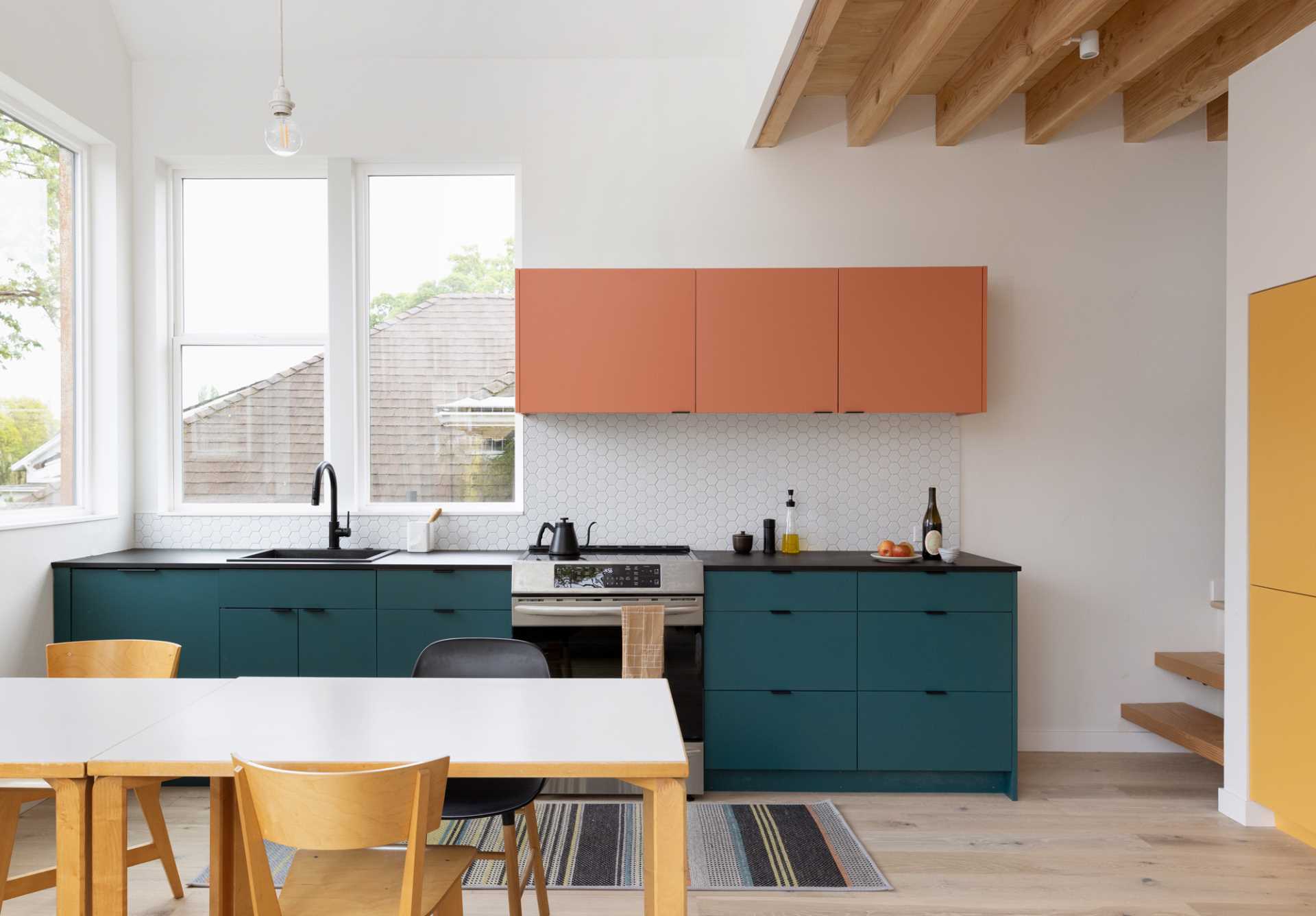 A modern kitchen with colorful cabinets.
