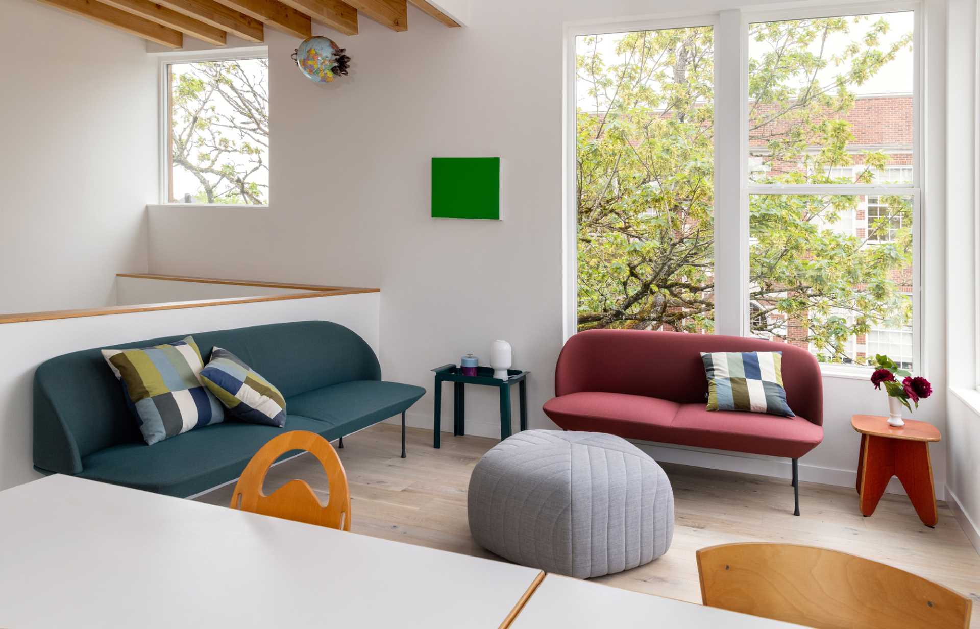 A modern living room with colorful furniture.