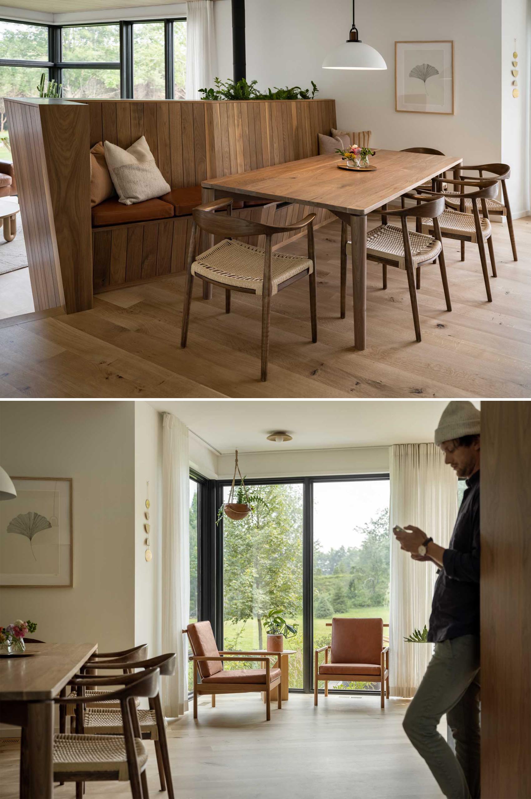 The dining room has a unique design, with a sculptural wood banquette bench that acts as seating for the table. A pair of chairs takes advantage of the window views.