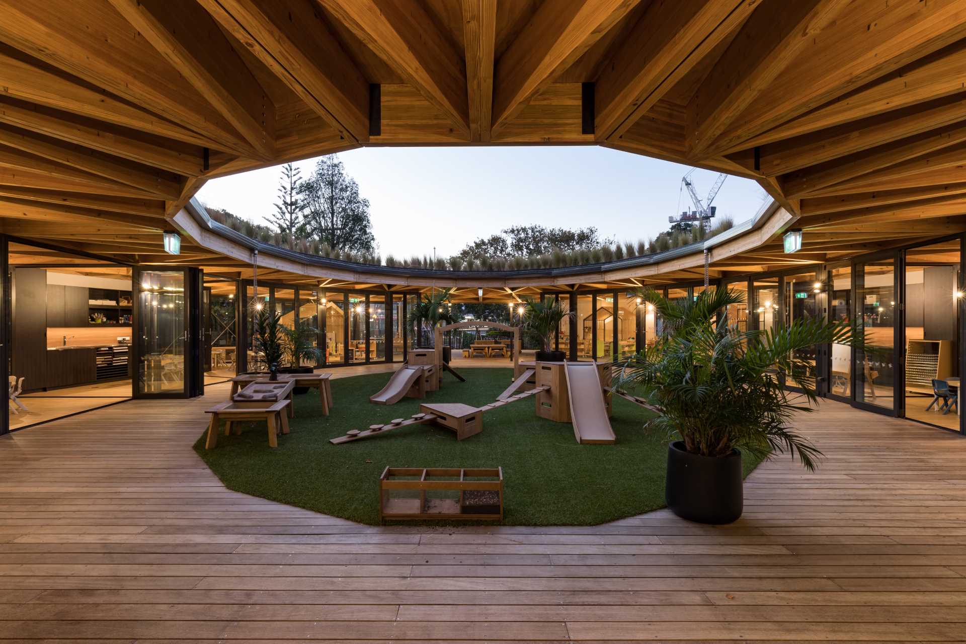 Natural grasses top a circular green roof of an early learning centre.