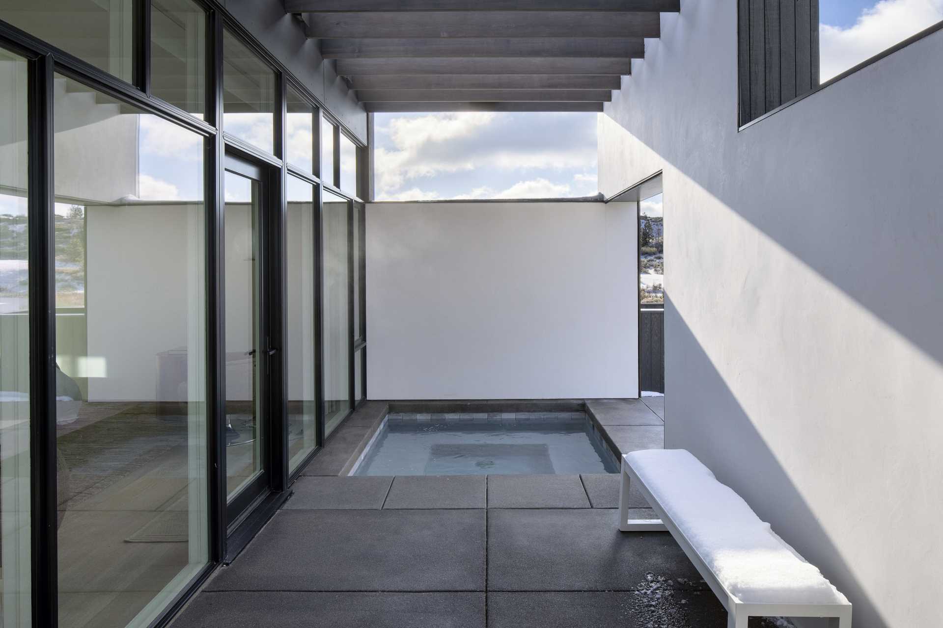 A modern home with a built-in outdoor hot tub.