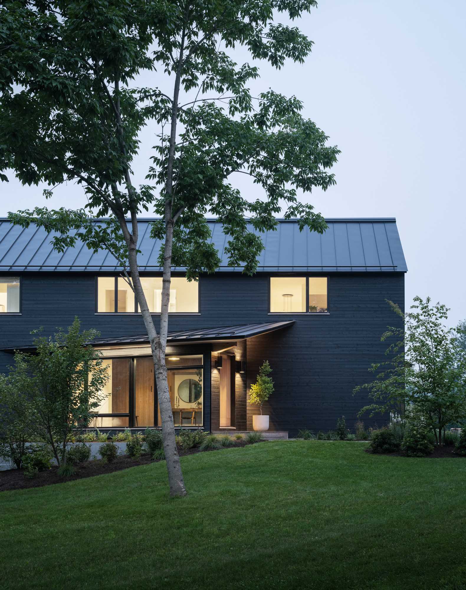 A modern house with black stained wood siding.
