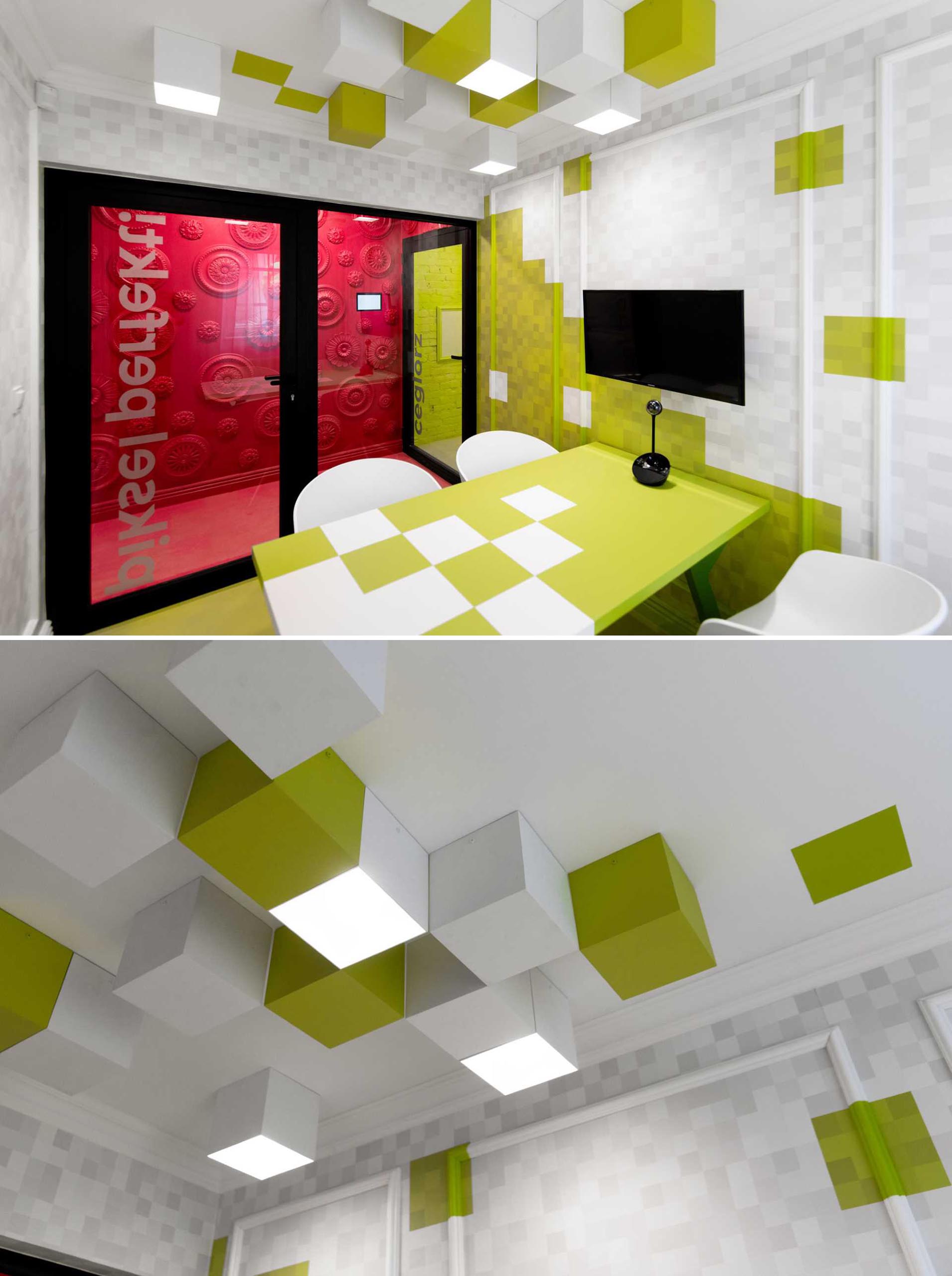 A pixel inspired meeting nroom has green squares on the walls as well as as the ceiling.