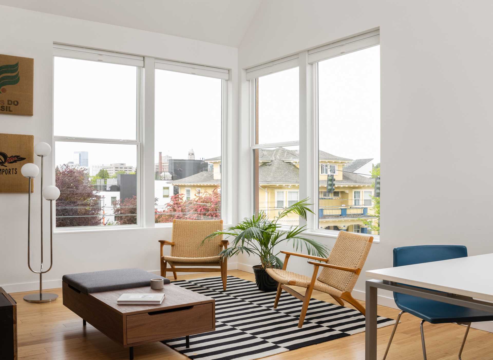 A modern living room with a black and white striped rug.