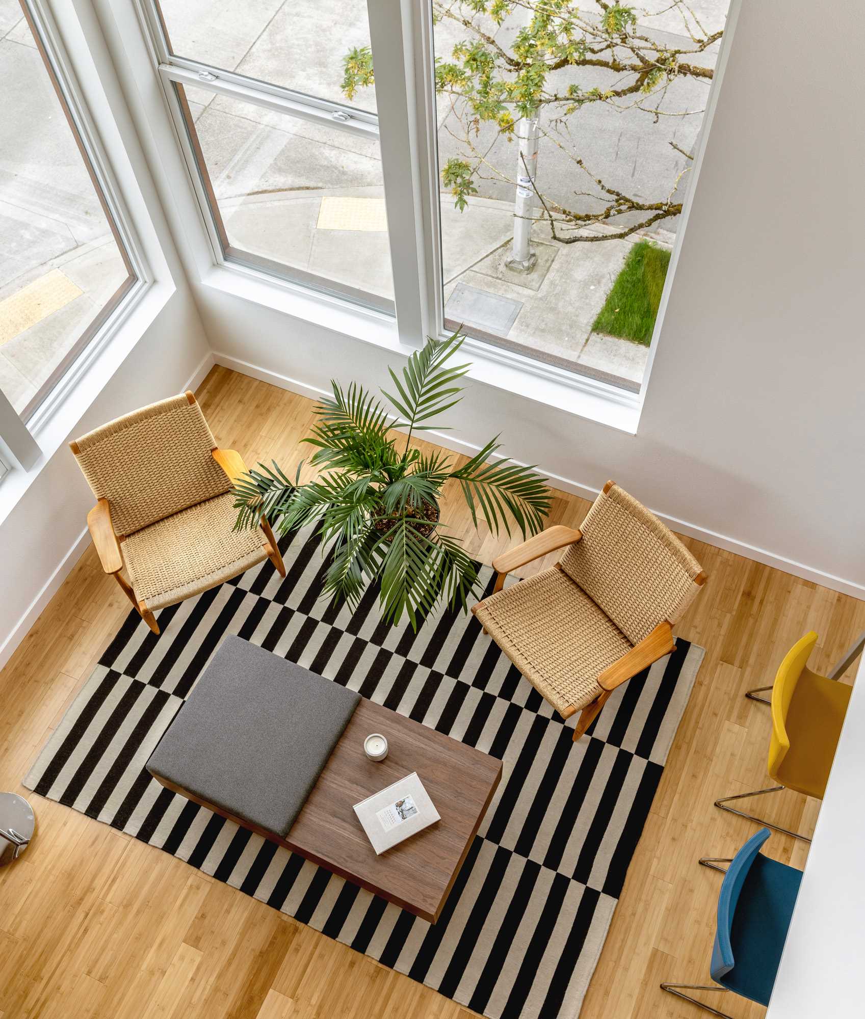 A modern living room with a black and white striped rug.