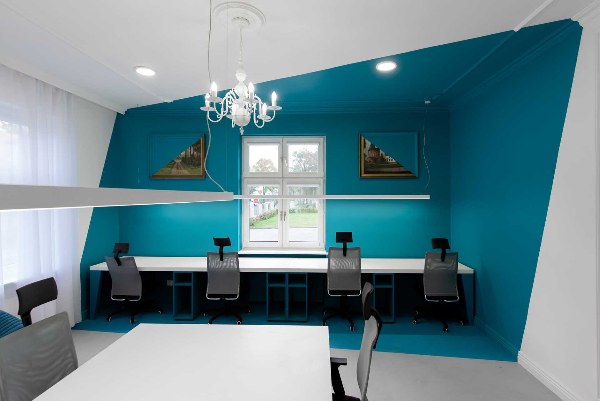 Turquoise abstract walls with matching painted decor create a unique look for this office interior.