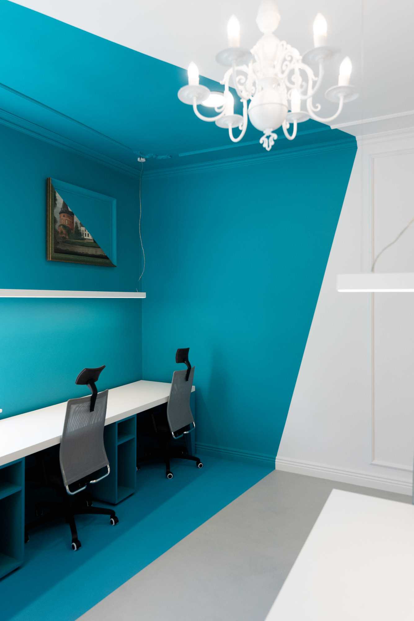 Turquoise abstract walls with matching painted decor create a unique look for this office interior.