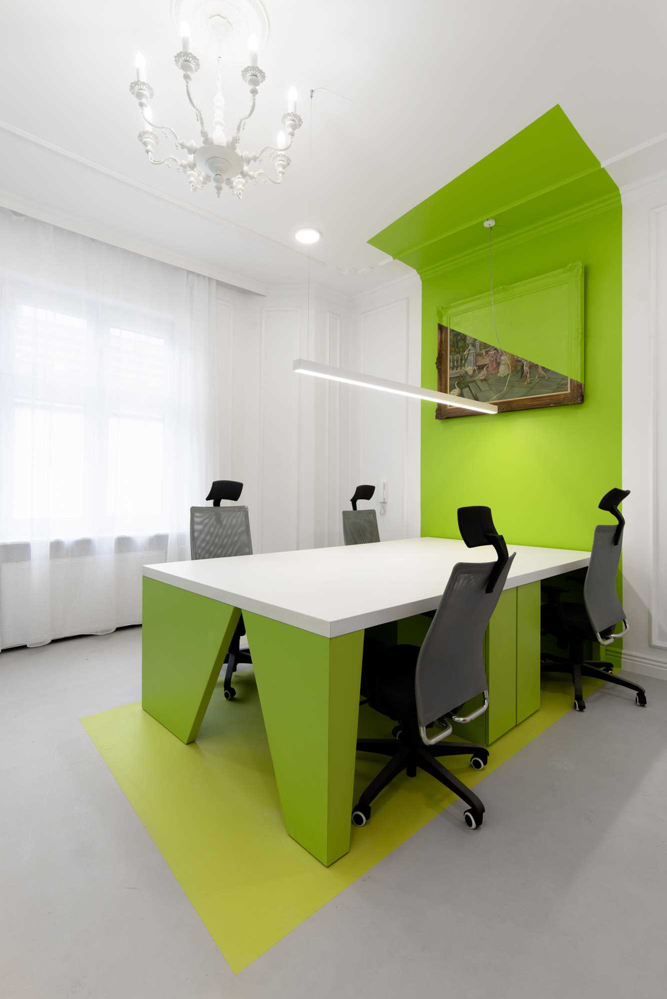 In this office meeting room, the painted walls wrapping from the ceiling, down the wall, and onto the floor, designating the space for the meeting tables and work areas.