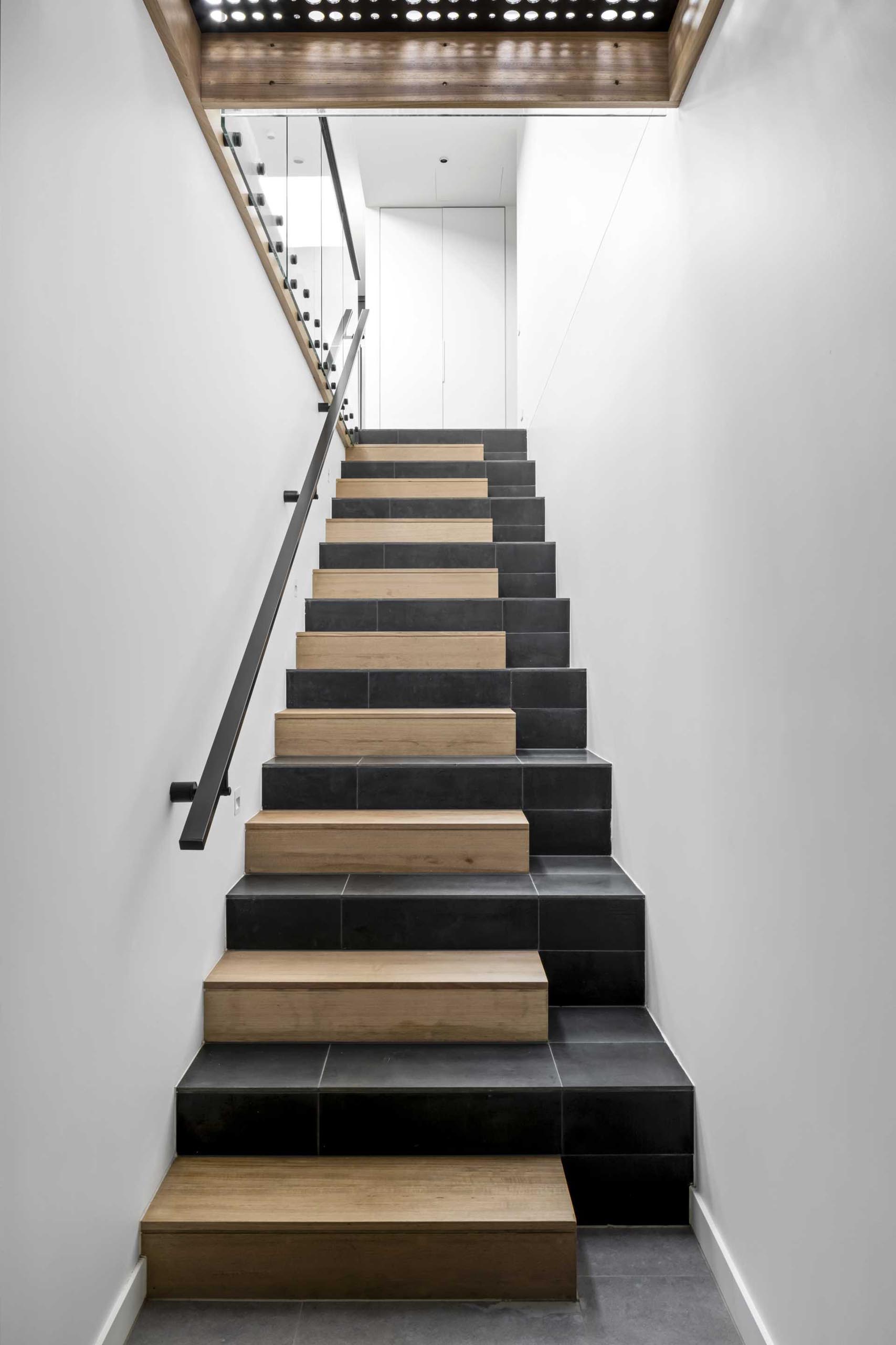 These modern stairs, which feature tile and wood, connect the various levels of the home.