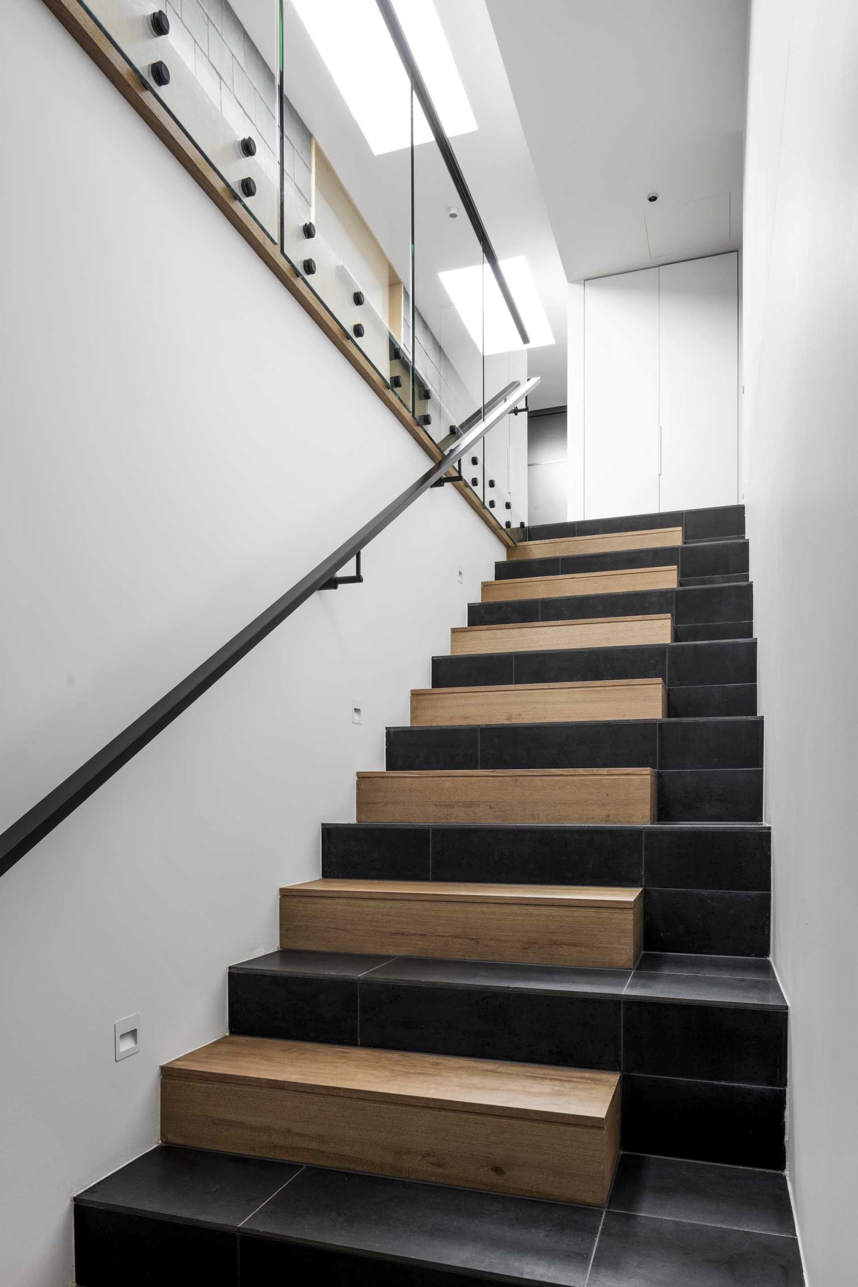 Modern wood and black tiled stairs.