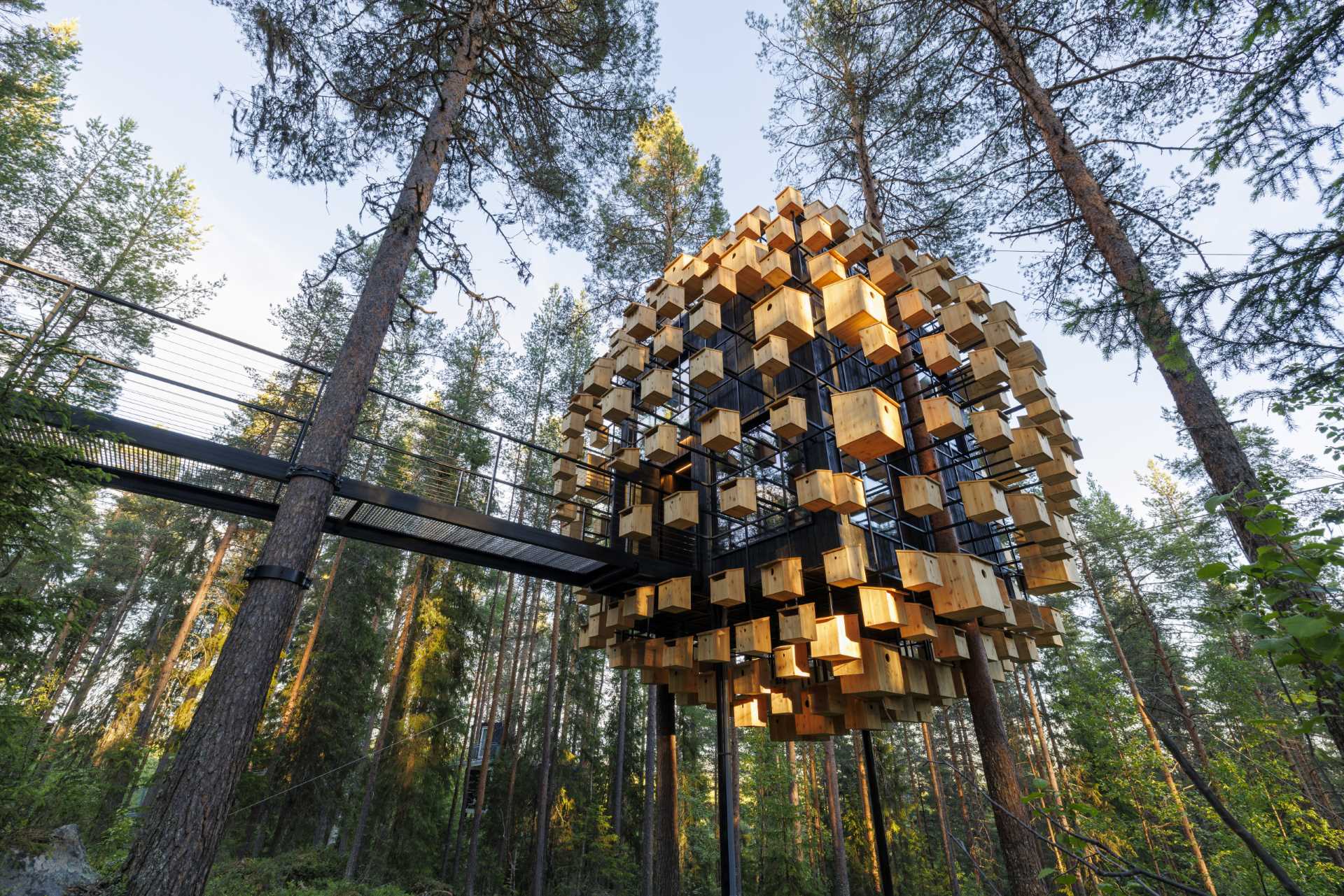 A suspended hotel room covered in 350 bird houses.
