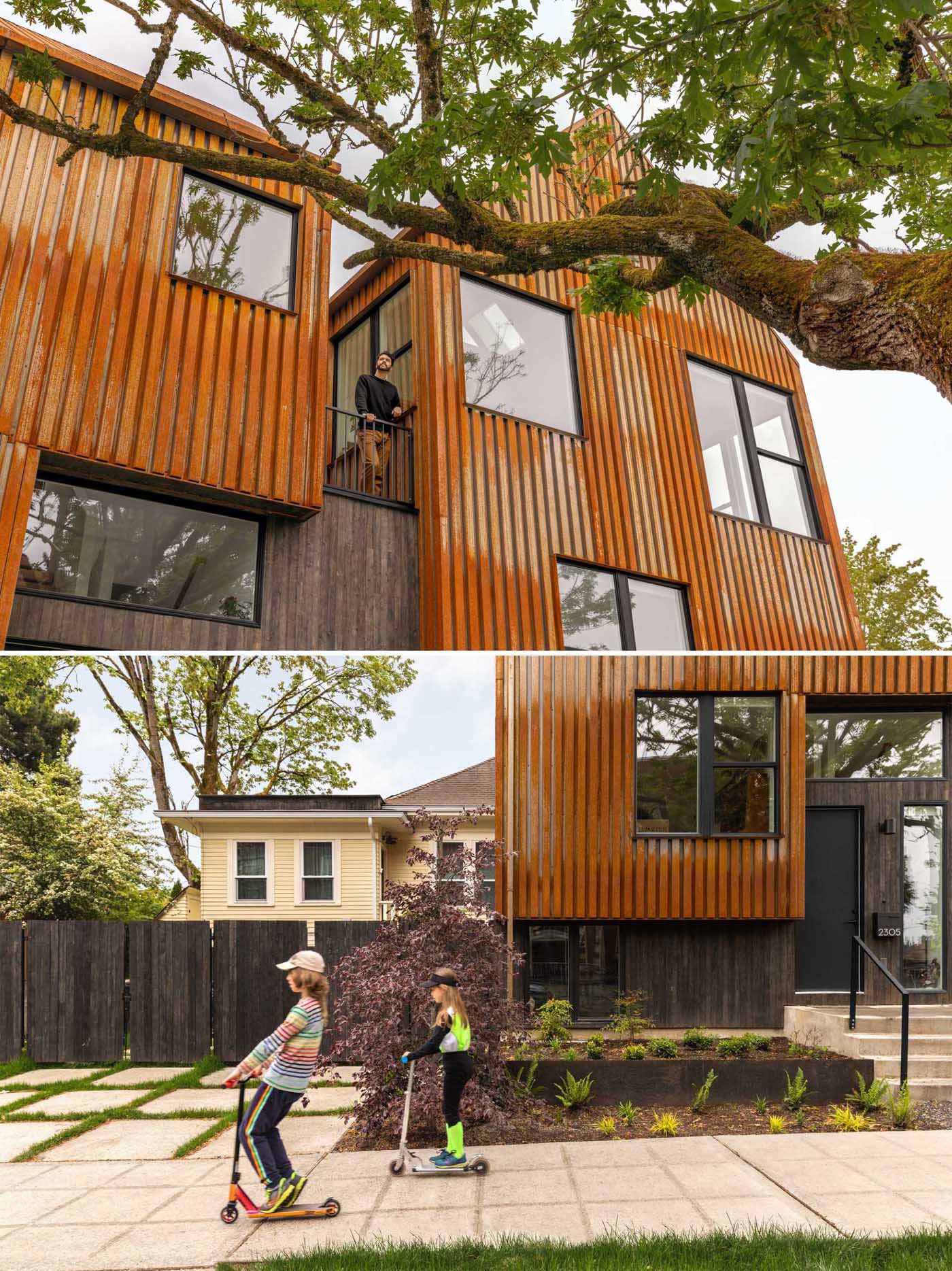 A modern townhouse on a corner, has an exterior clad in rusted corten steel.