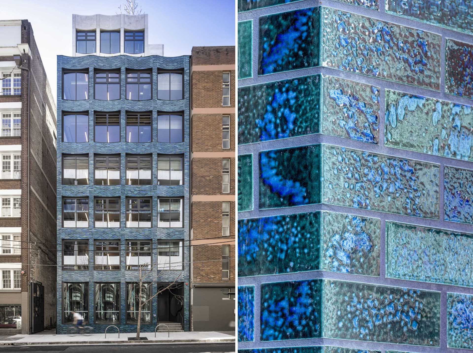 A modern building with a scalloped facade and aquamarine glazed bricks.