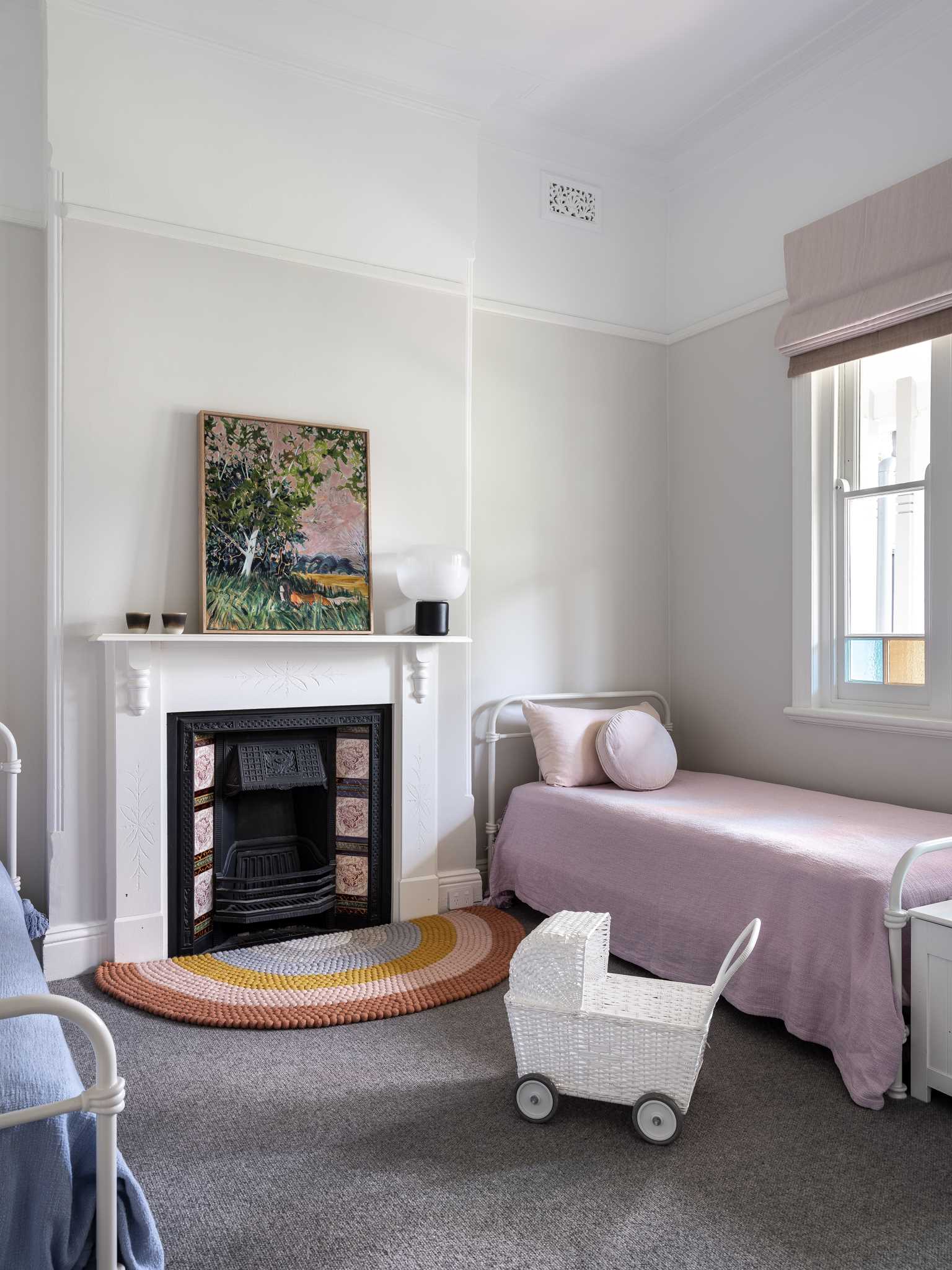 A cute kids bedroom with a pink theme.