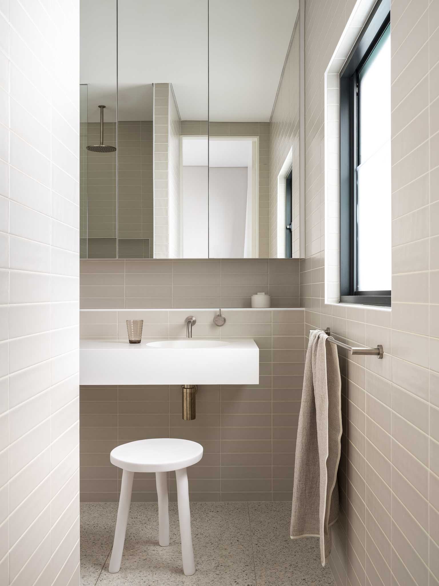 A modern bathroom with a natural color palette.
