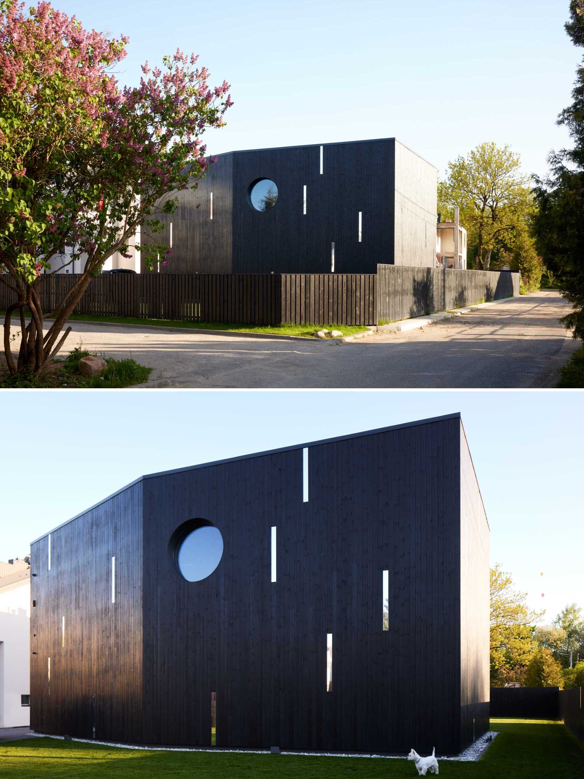 The dark wood facade of this modern home is accented by mirrored details.