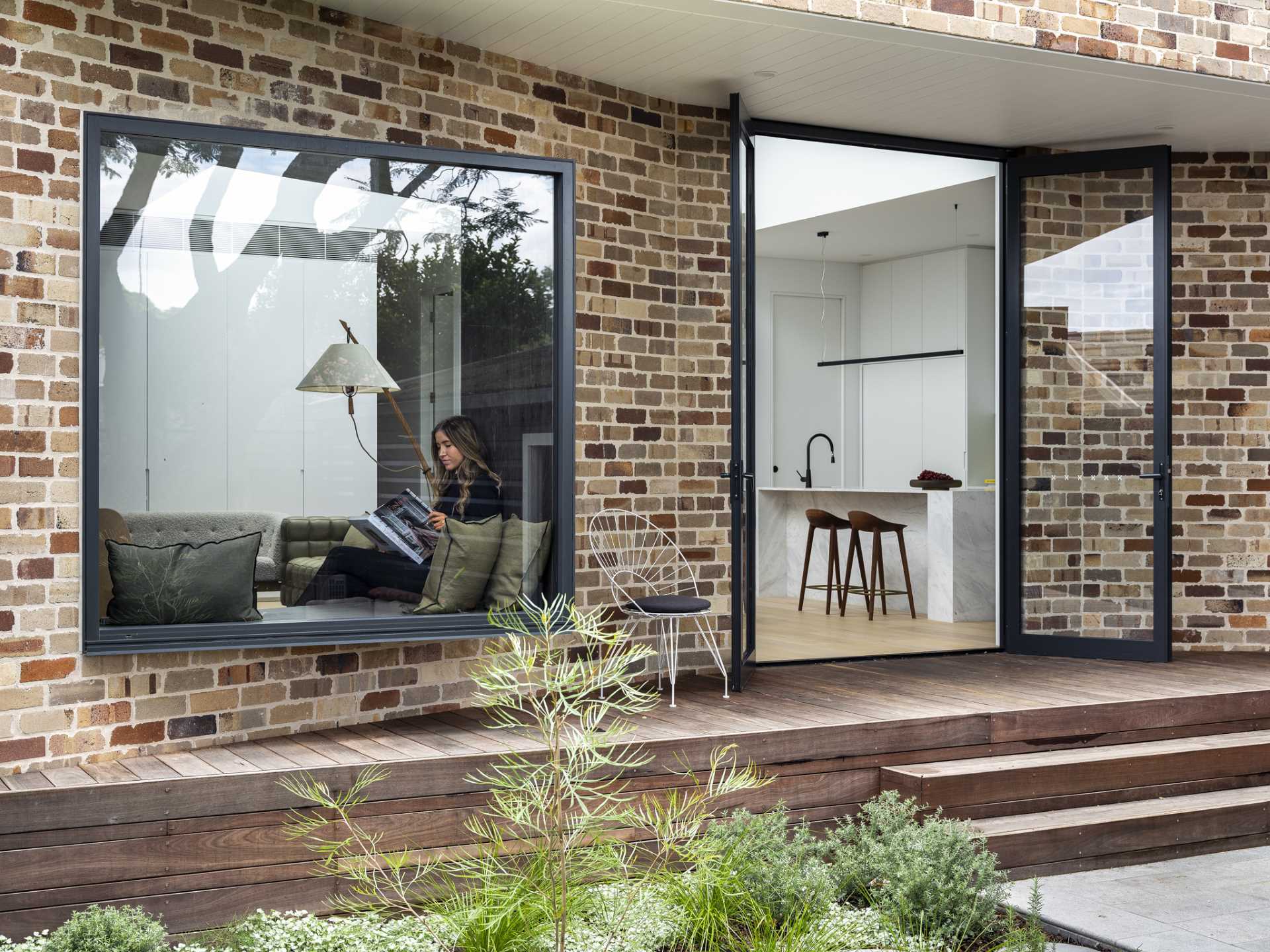 The recycled brick rear addition has been designed in a way that an overhang provides shade for the wood back deck.