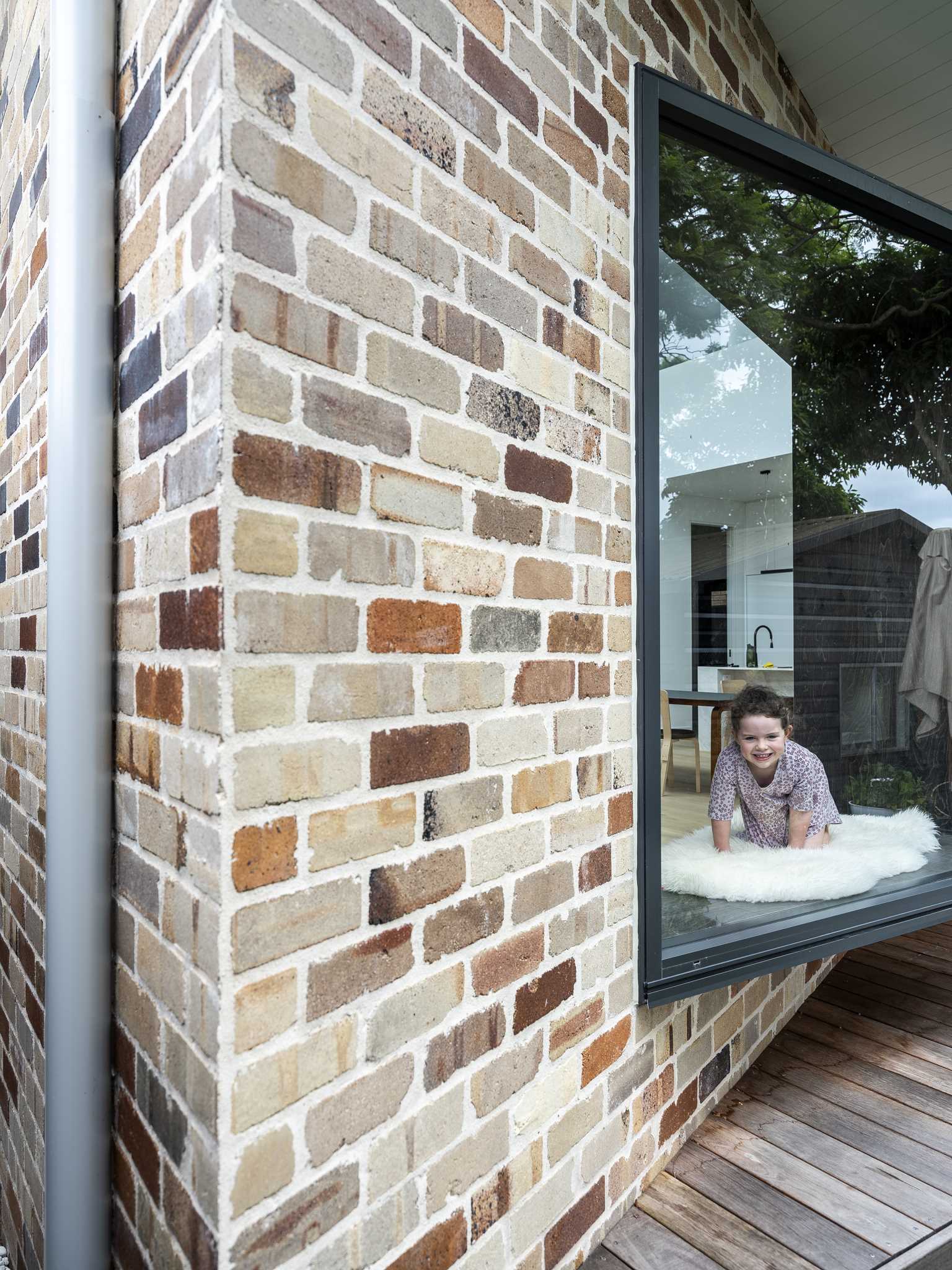 A recycled brick addition with a window seat.