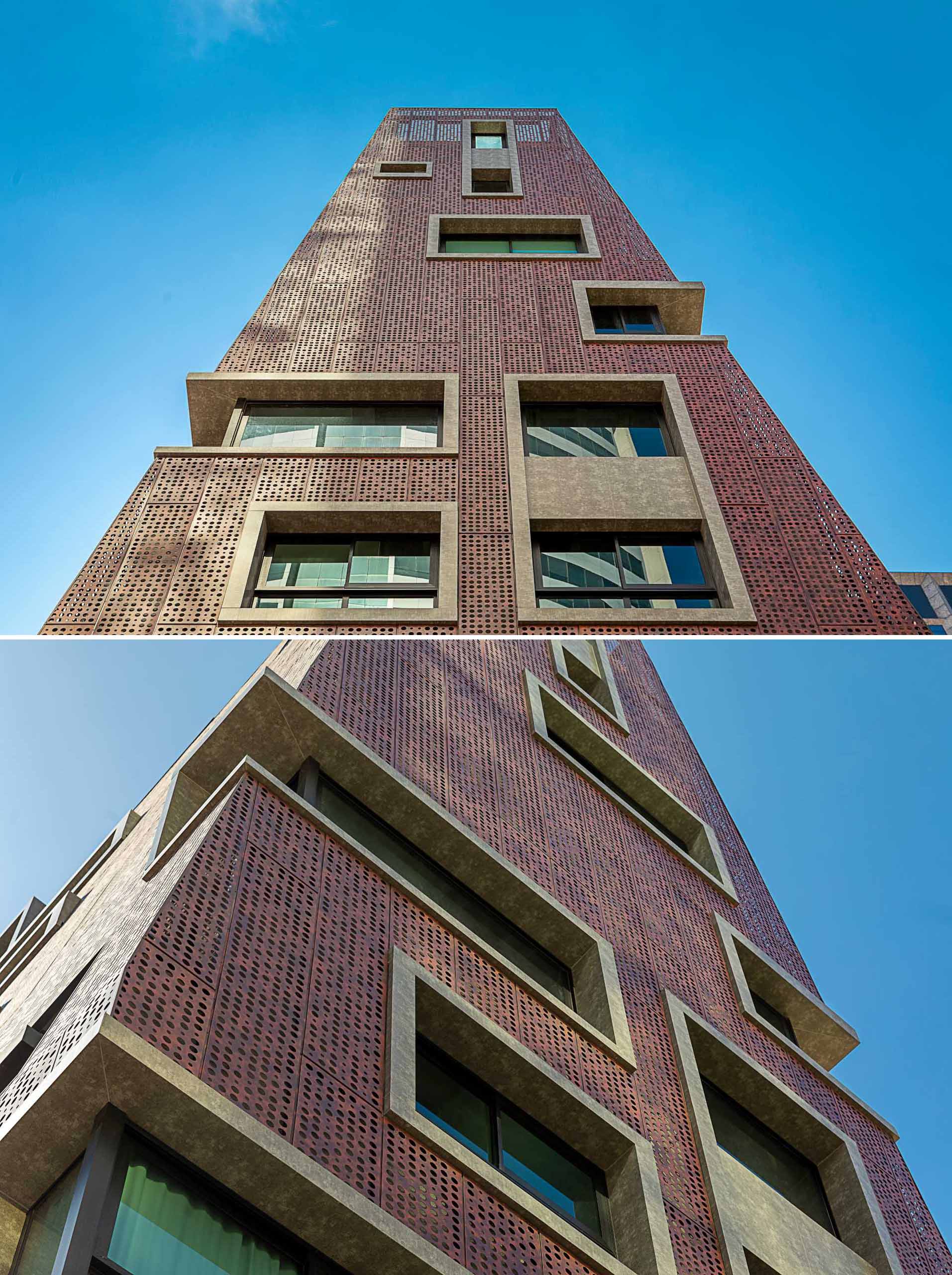 A modern residential building with concrete window frames and perforated metal panels.