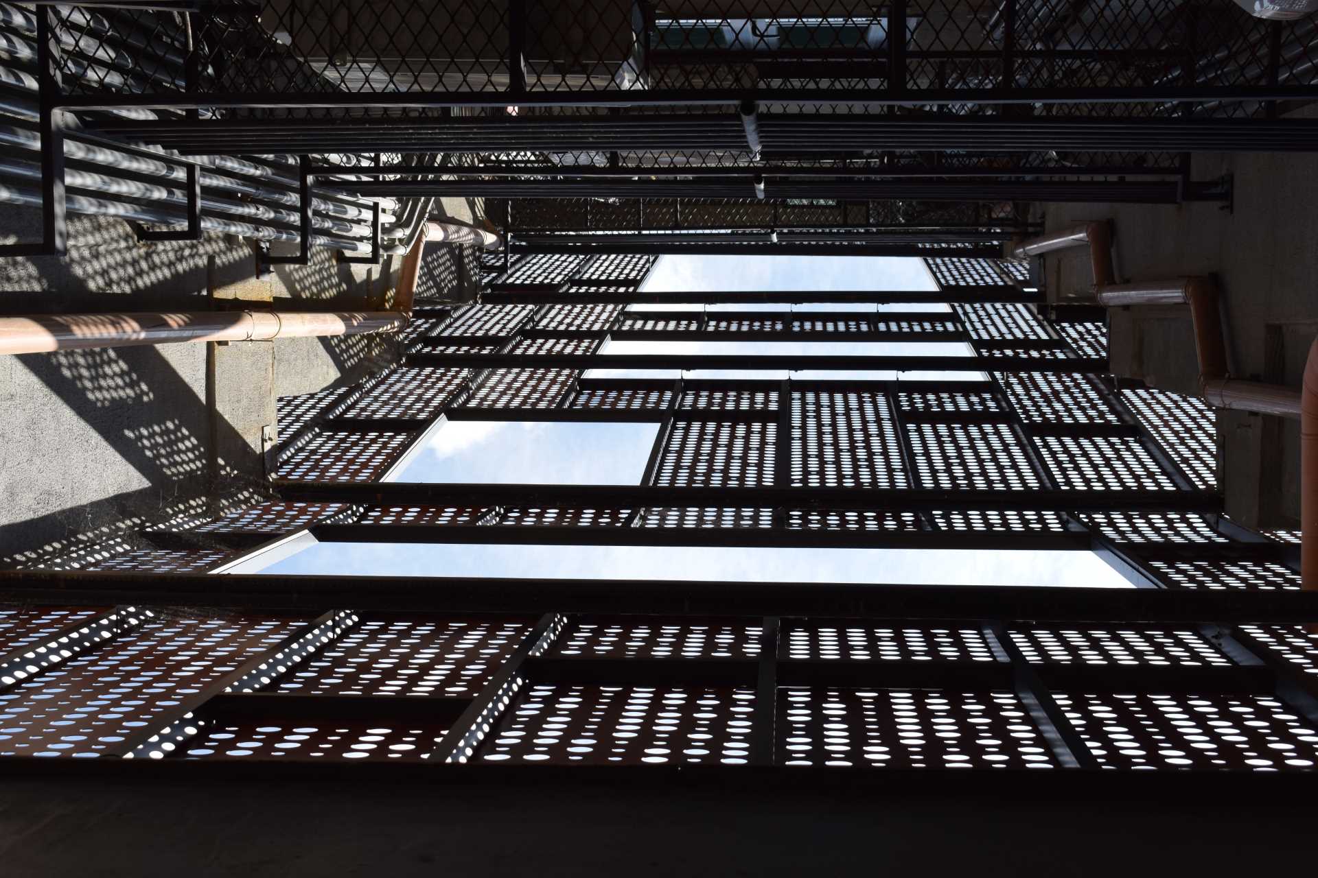 Perforated metal panels cover the exterior of a residential building.