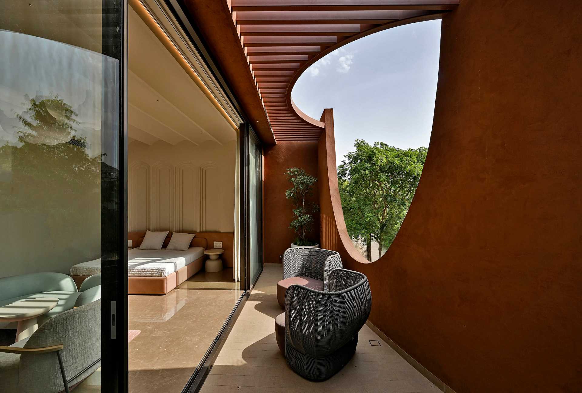 A modern bedroom with a partially covered patio.