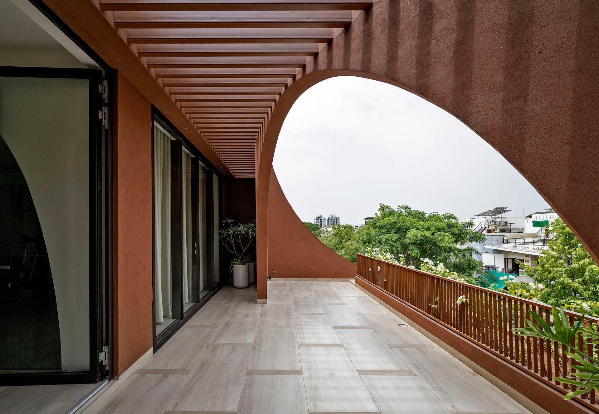 A modern house with a patio and curved accents.