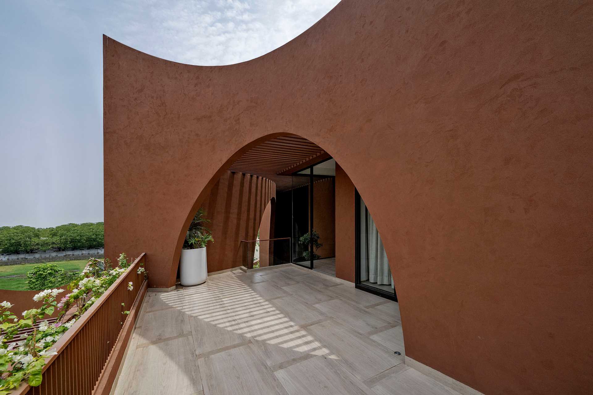 A sculptural house with arches scattered throughout its design.