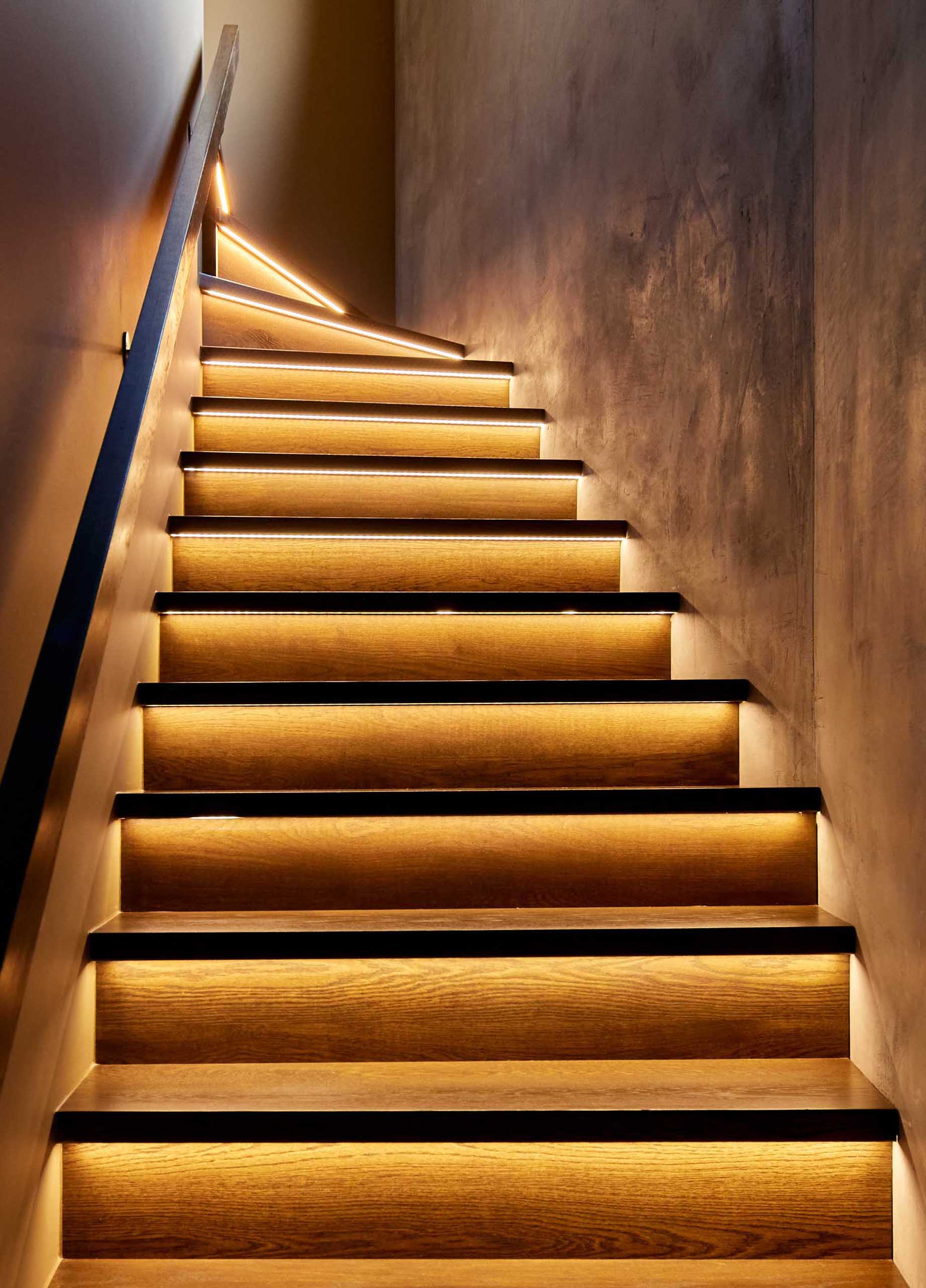 In a close-up look at these modern stairs, you can see the hidden LED lighting strips that are located underneath the tread, and highlight the stair riser.