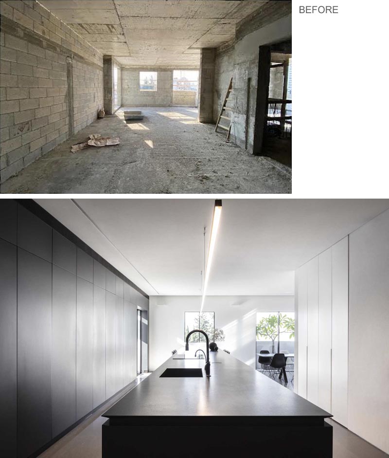 In this kitchen, minimalist cabinets in a shade of graphite and white line the wall, while the island is covered with black granite and extends to include space for seating.