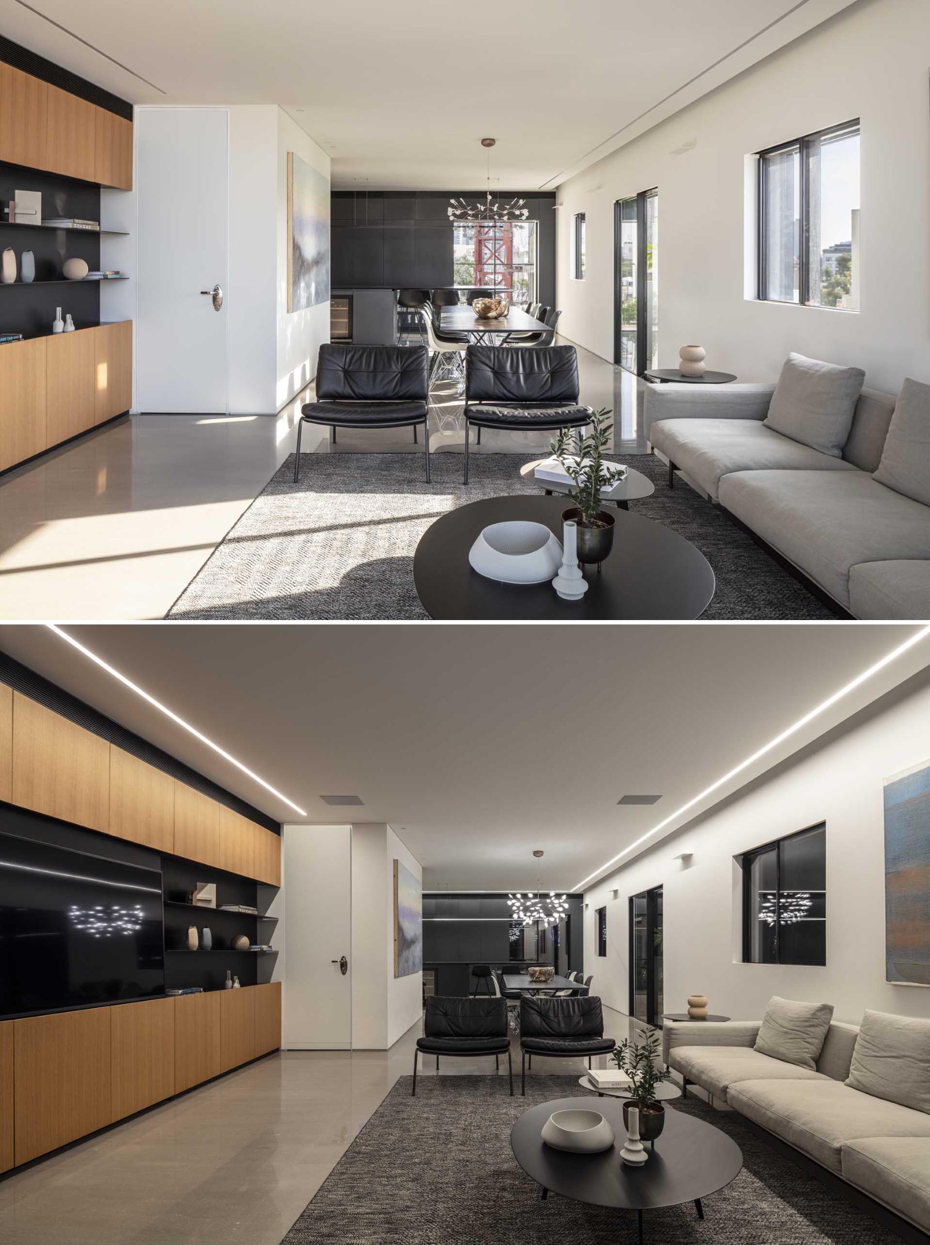 Clean lines are featured throughout the interior of this penthouse apartment, like in the living room, where a wall of cabinetry lines one side of the room, and a large sliding door opens to the pool. Lighting in the ceiling helps to define the shape of the living room.