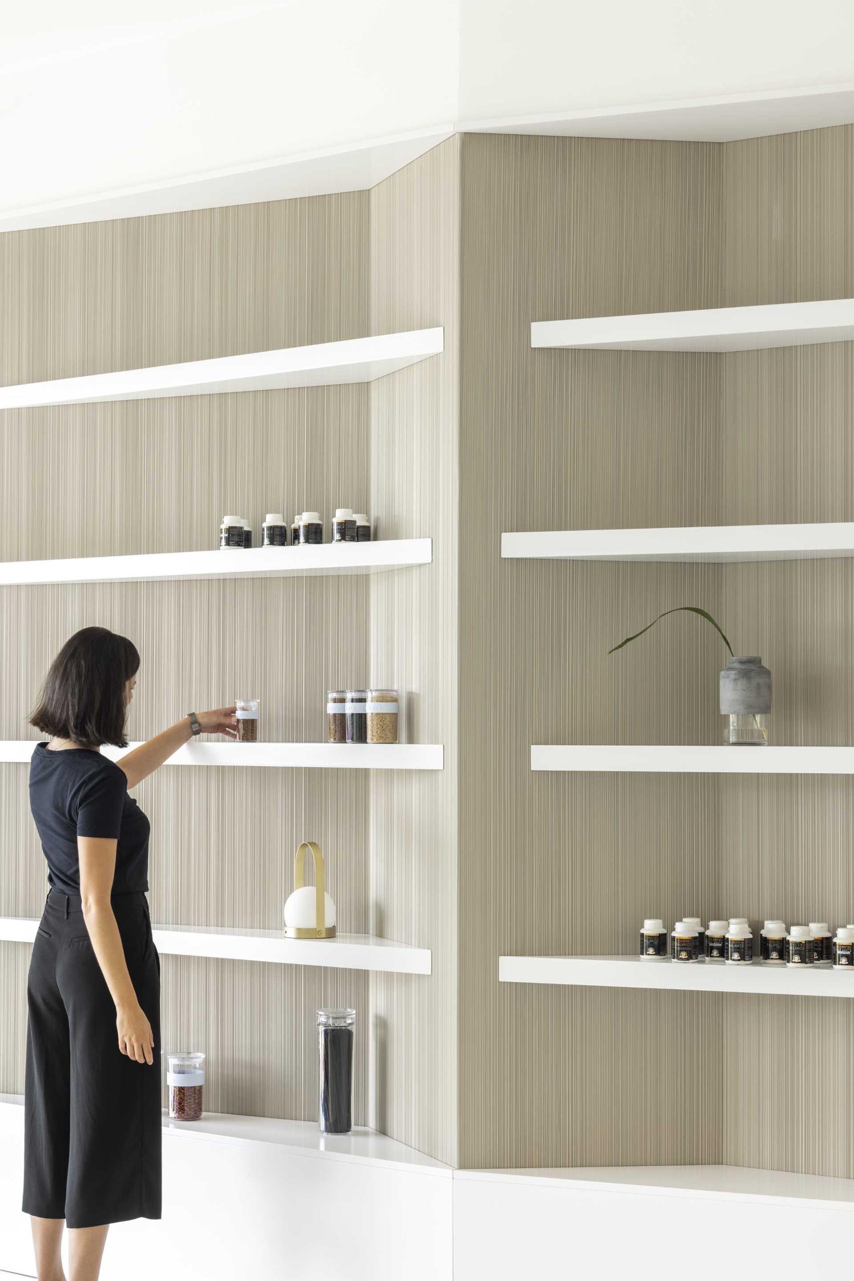 A modern health clinic with a natural color palette includes white display shelves.