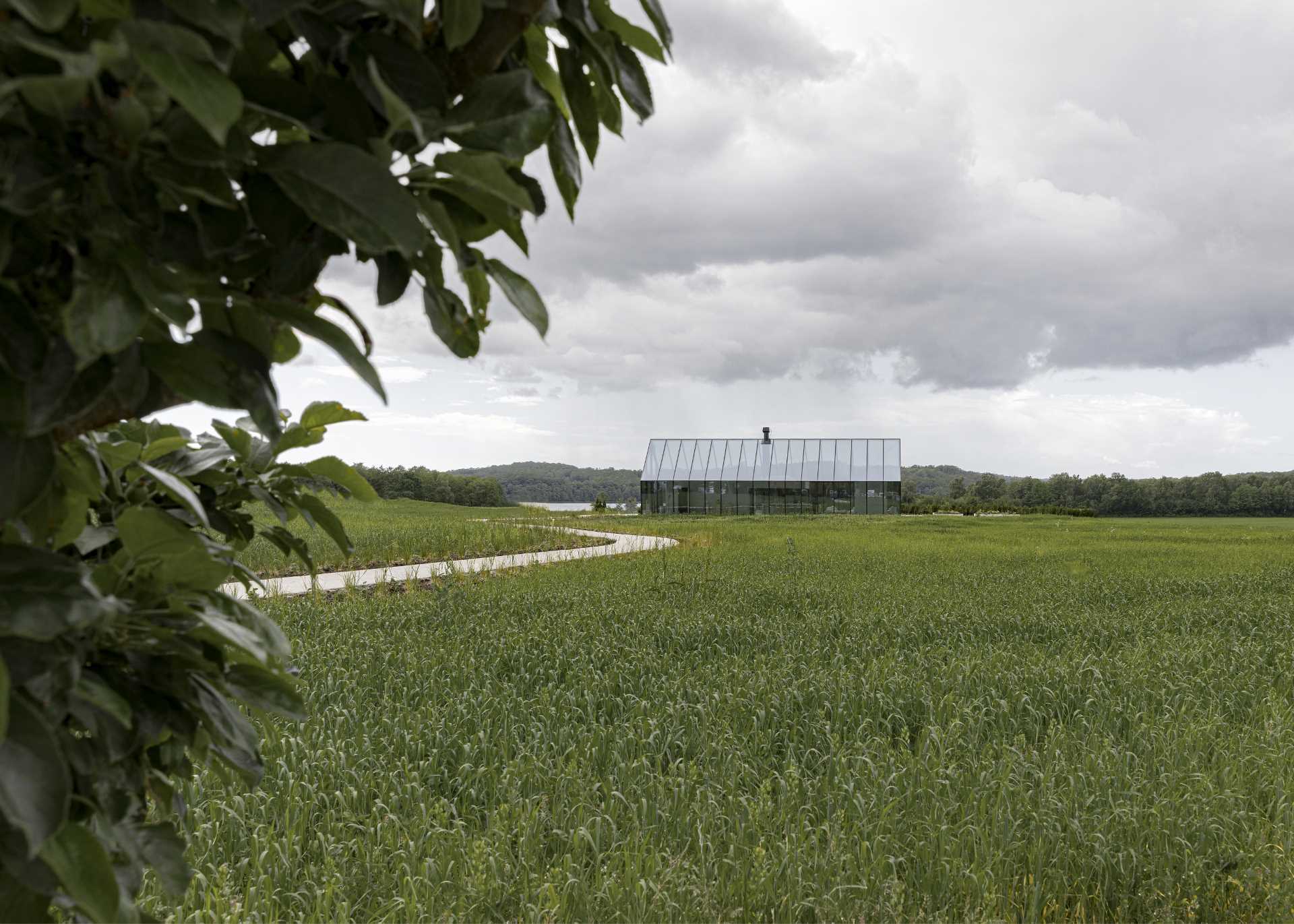 The glasshouse, which has bold black frames, acts as an entrance to the partly underground Michelin-starred restaurant.