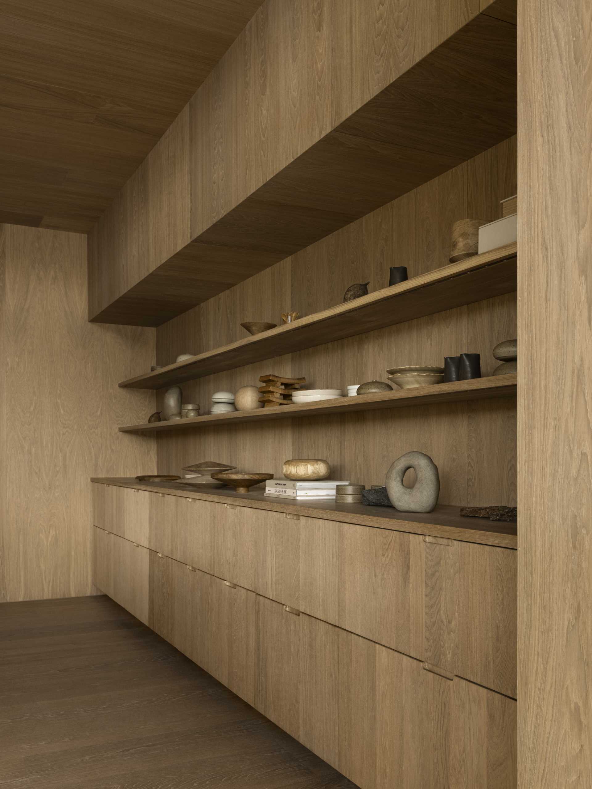 Oak shelving and cabinetry designed to display decorative items.