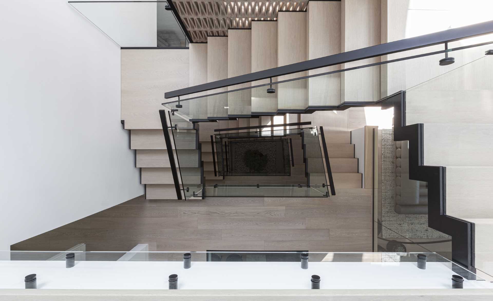 A modern staircase connects the various levels of this modern home.